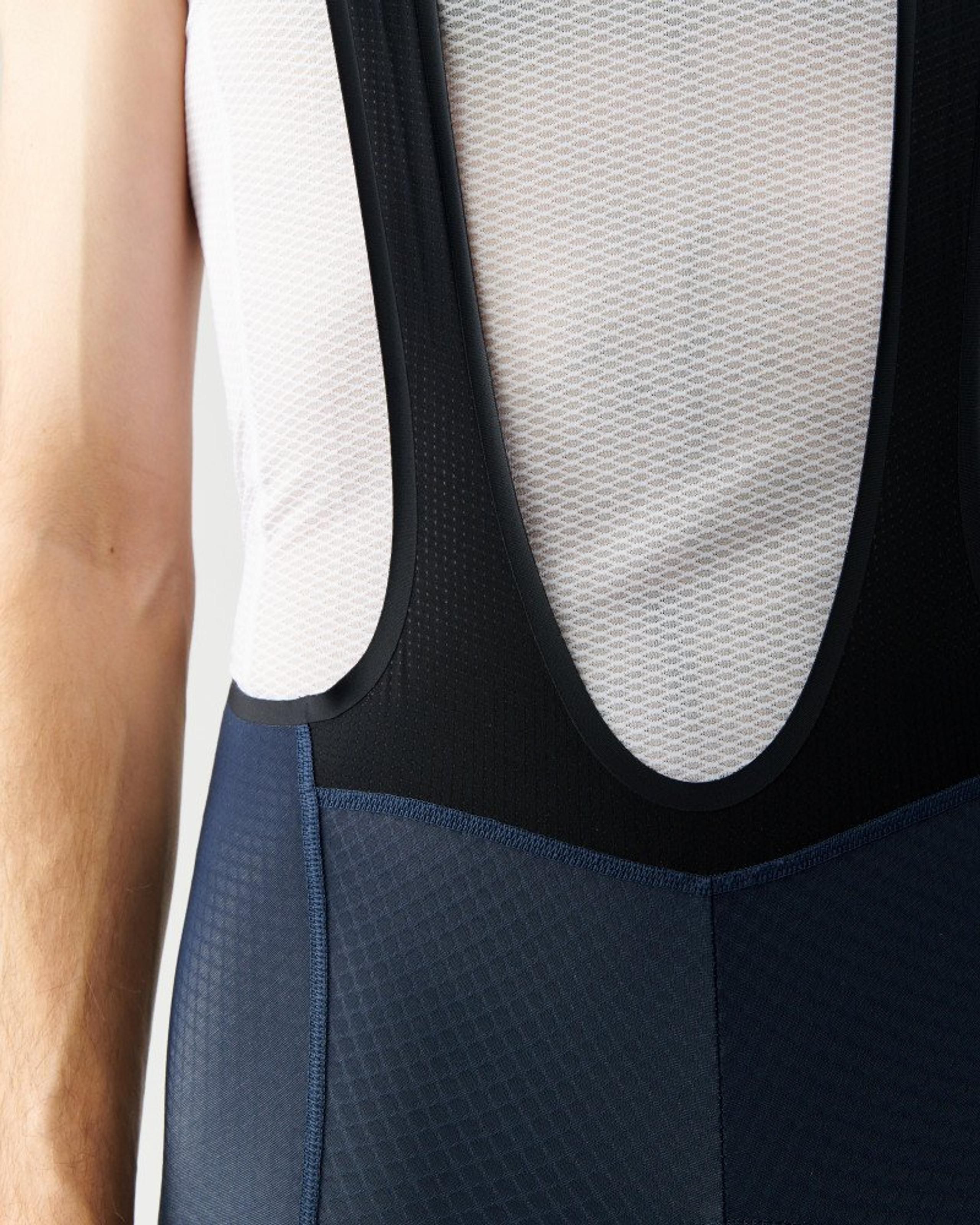 Navy Essential cycling bibs on model with white mesh back panel