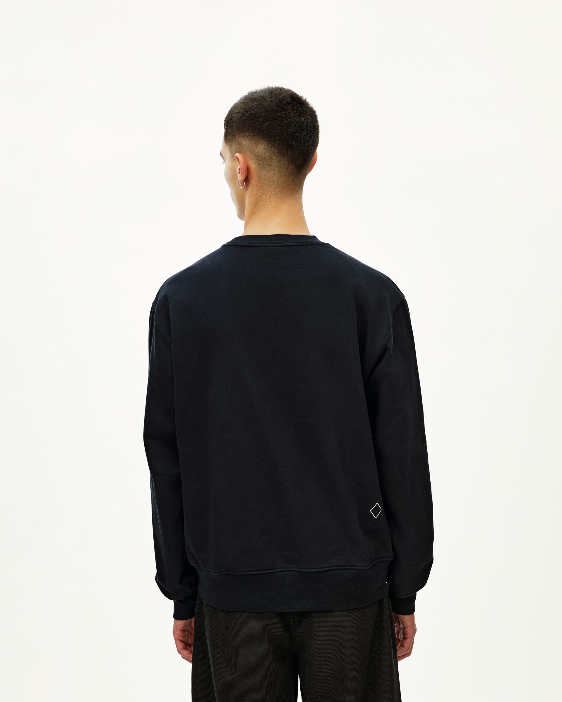 Black Off-Race sweatshirt, rear view on model with small diamond logo patch at hem