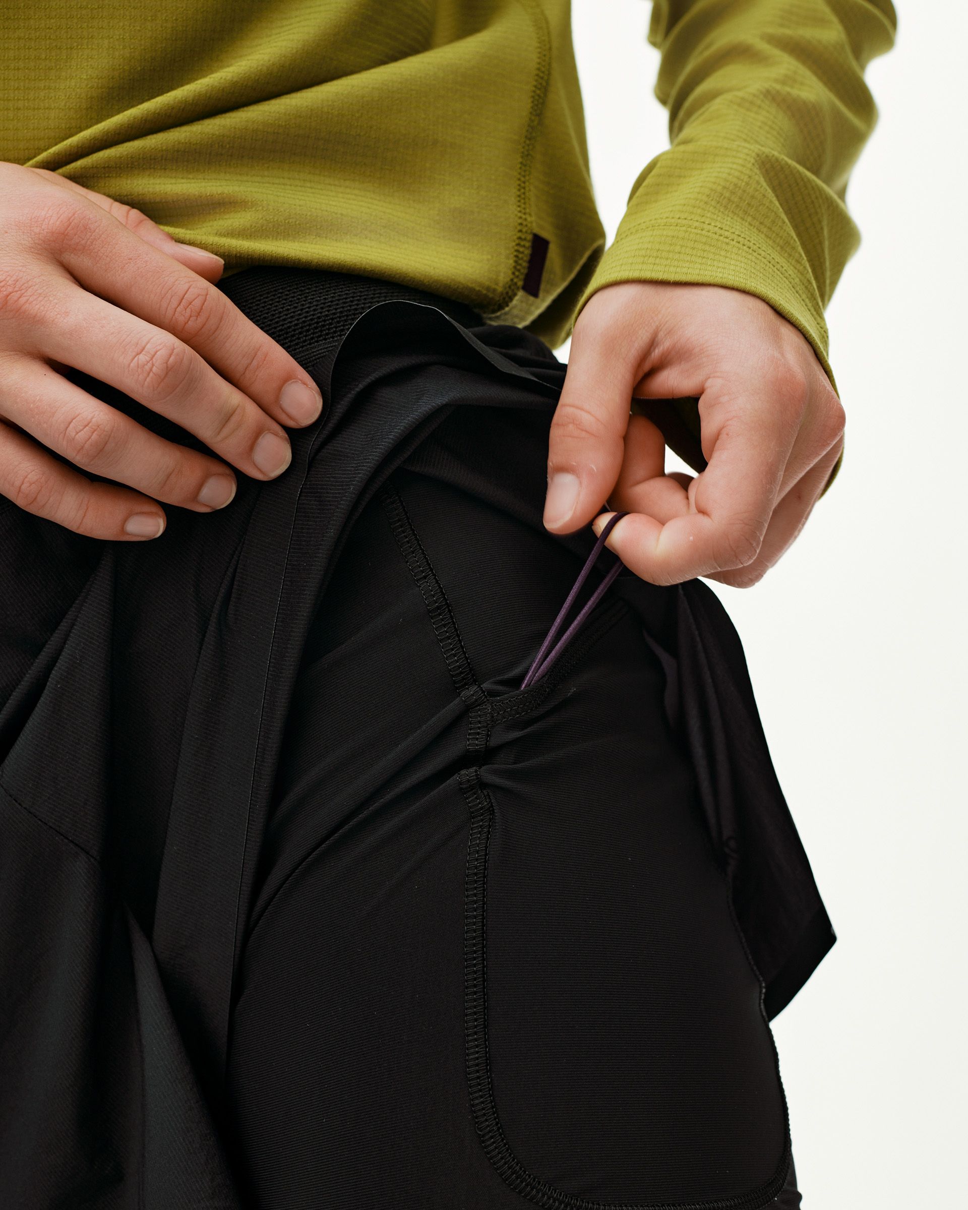 Black Balance 2-in-1 shorts, detail view on model showing inner liner with purple drawcord