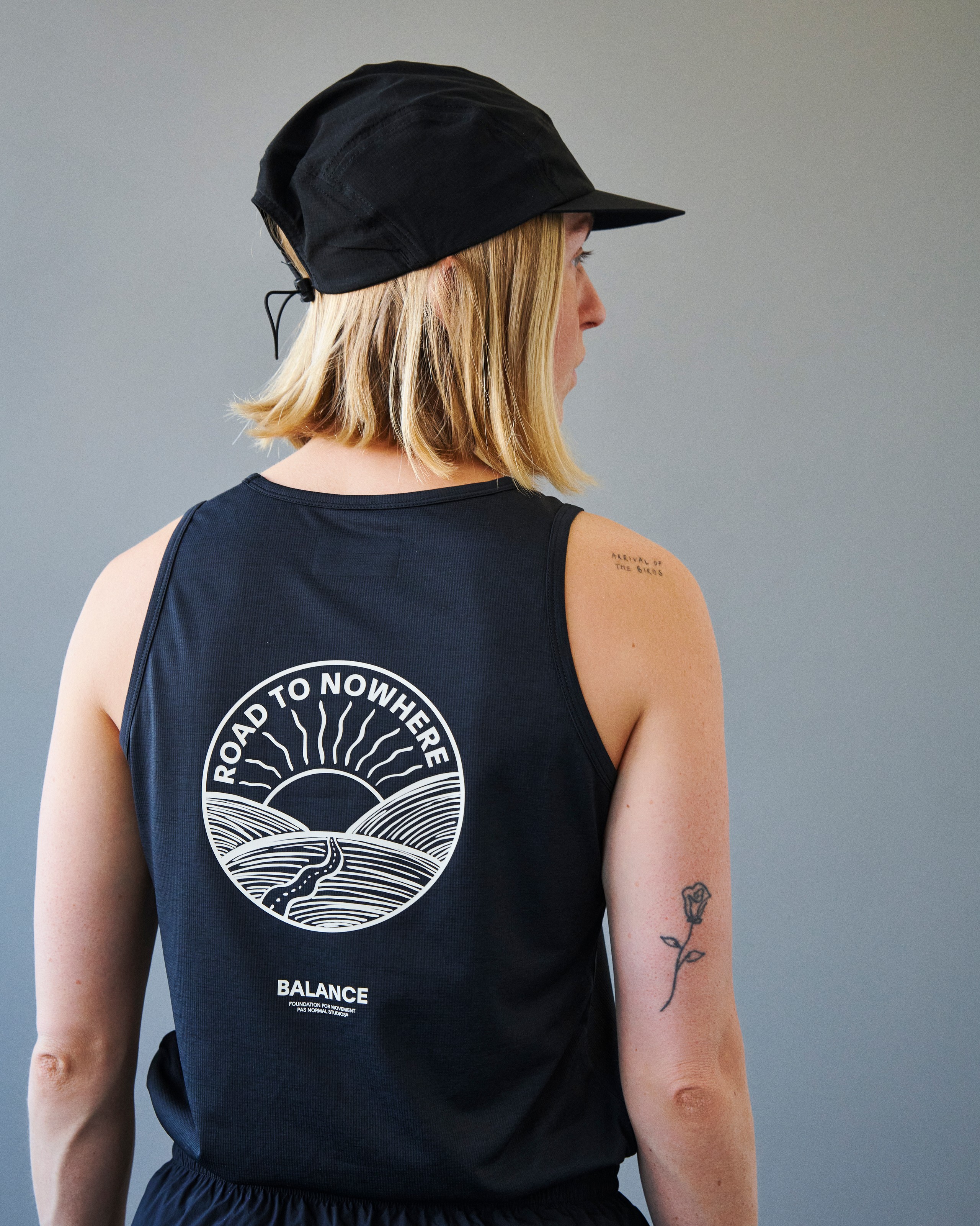 Black Balance singlet on model, rear view with white Road to Nowhere sunrise print