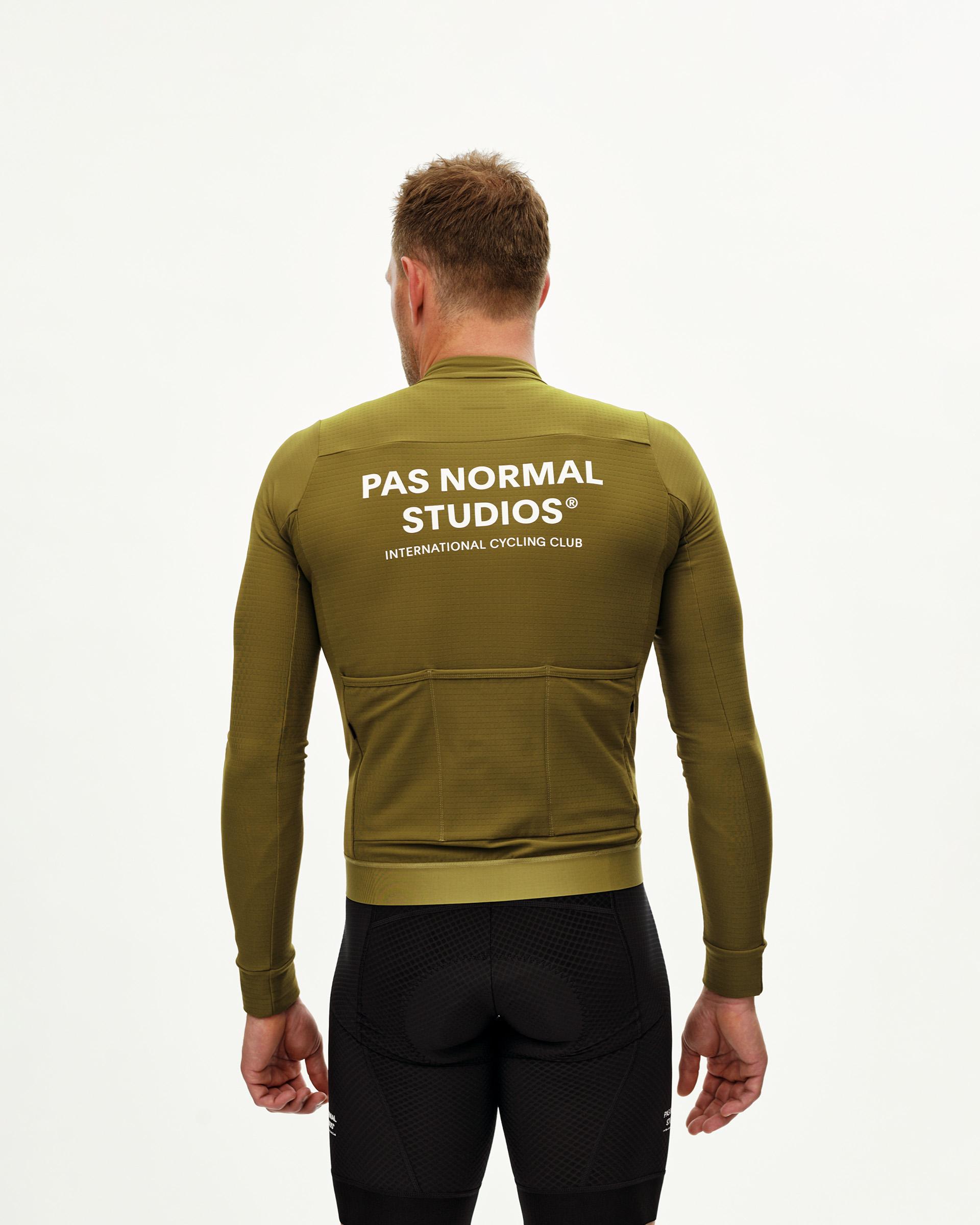 Khaki Green Essential long sleeve cycling jersey on model, rear view with white back print