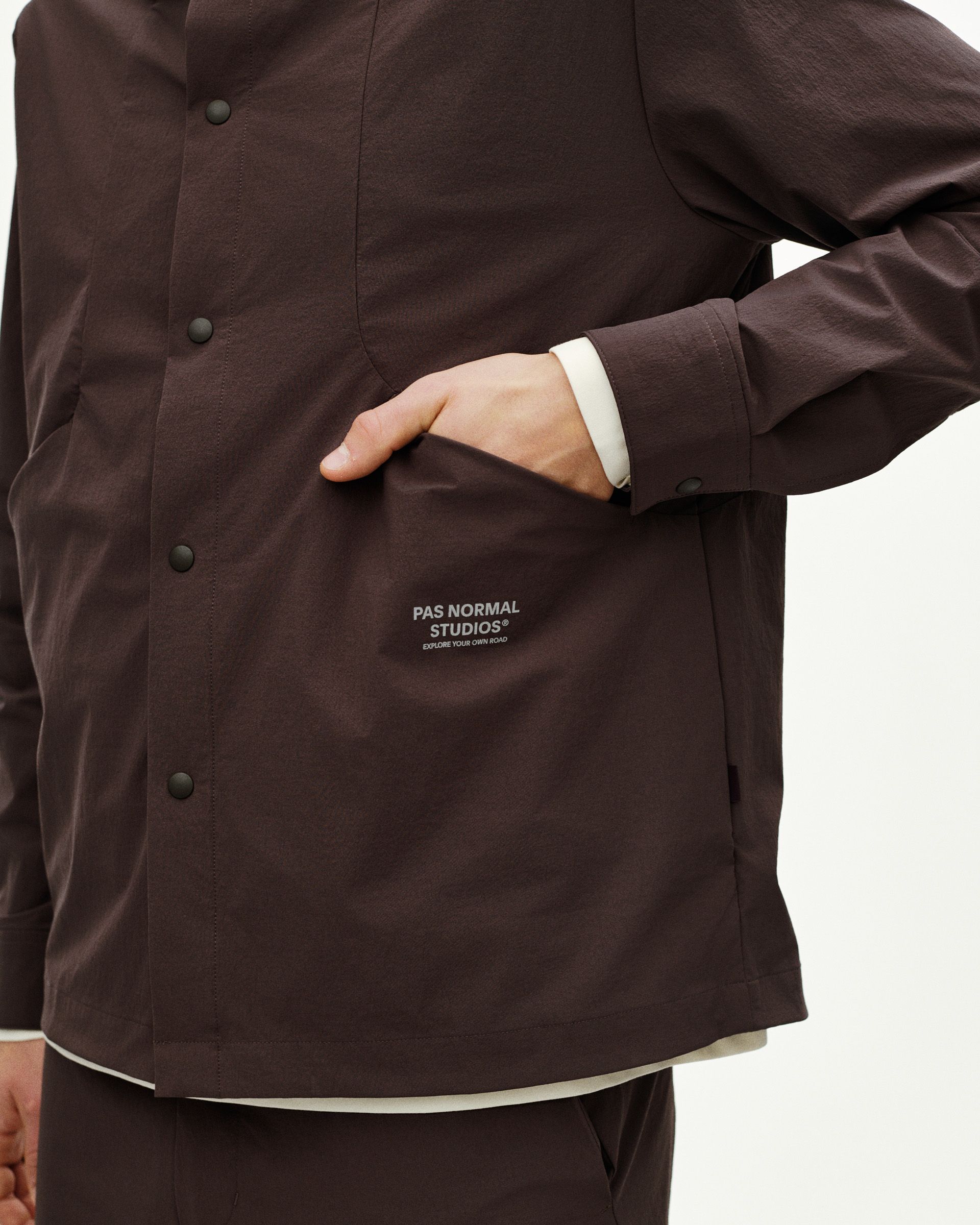 Dark Purple Off-Race Tech Overshirt on model showing snap button closure and chest logo