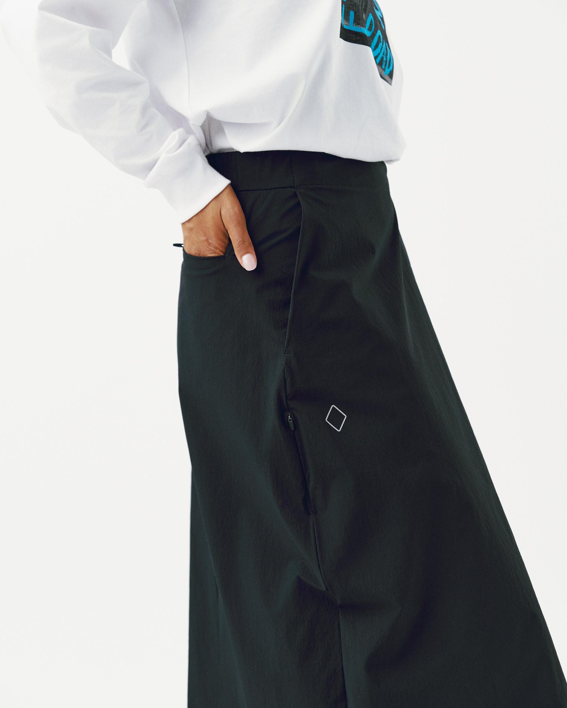 Black Off-Race Tech Skirt on model with side zip and logo detail