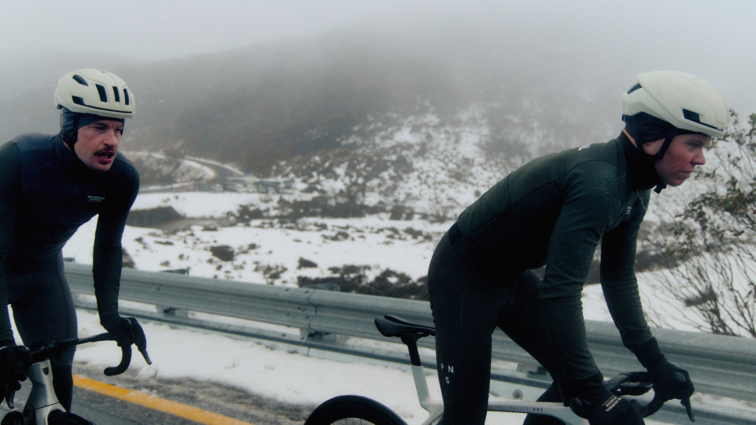 Black Mechanism Deep Winter bibs on cyclists in winter mountain landscape
