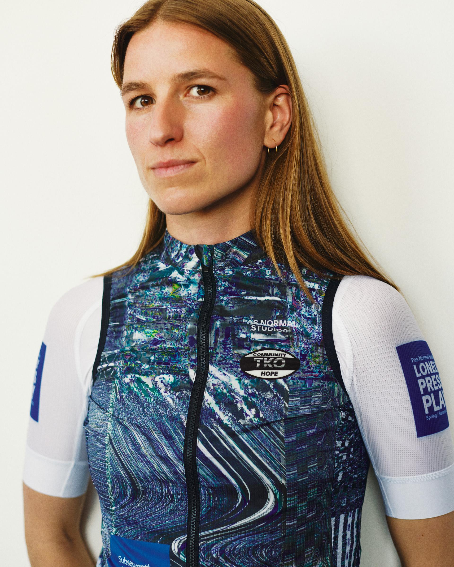 Human Error Blue T.K.O. Mechanism Stow Away cycling gilet on model, front three-quarter view with digital glitch AOP print