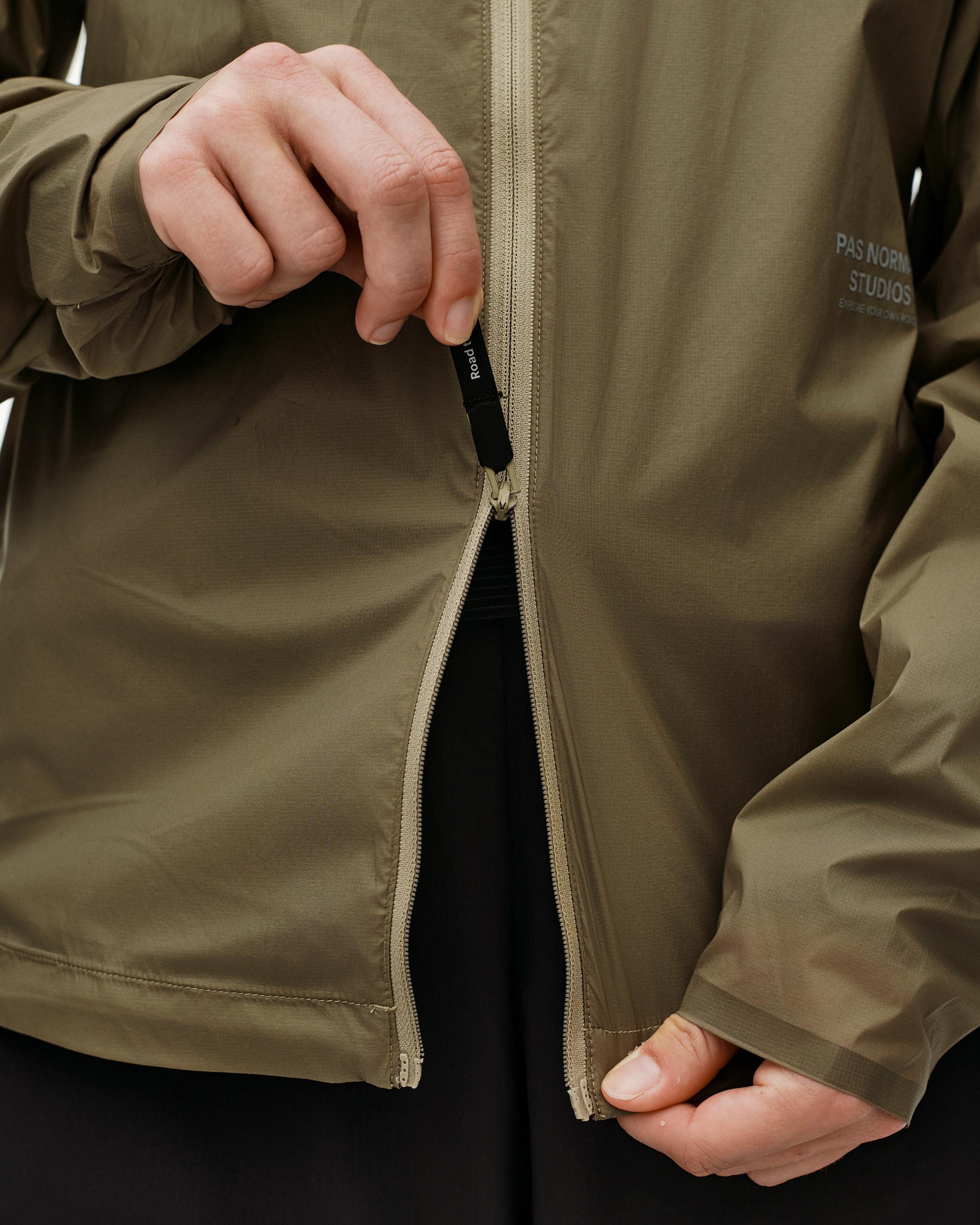 Dusty Earth khaki Balance Windproof jacket, front detail on model with open full-length zip