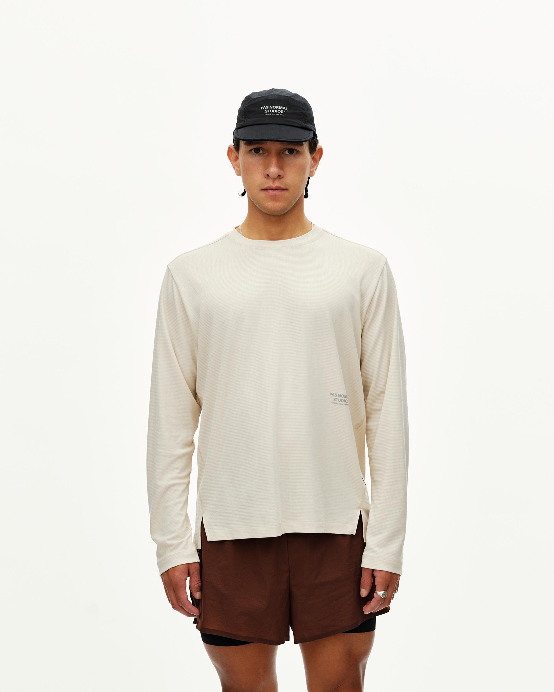 Sand Balance long sleeve T-shirt on model, front view with tonal chest logo print