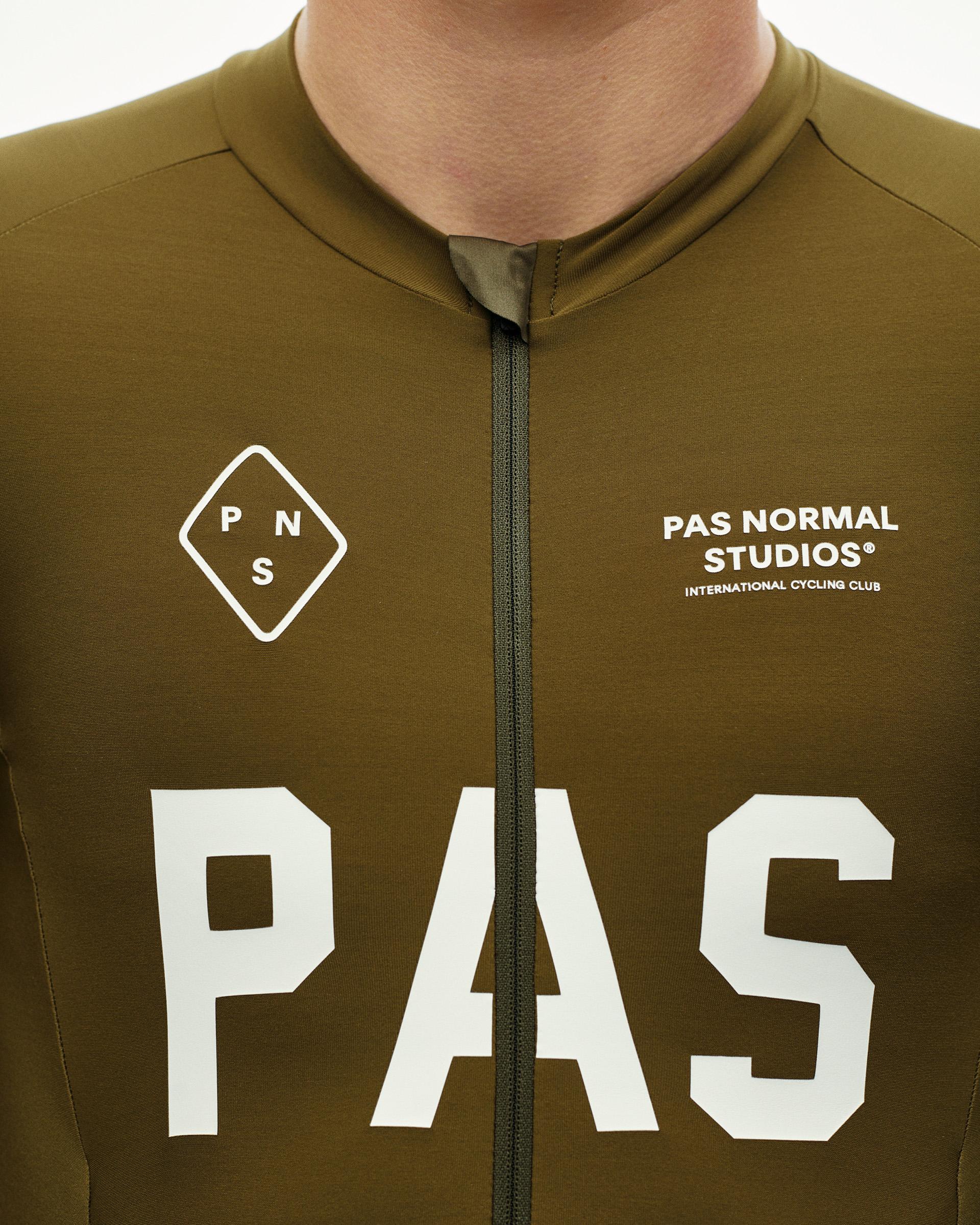 Moss Brown PAS Thermal cycling speedsuit, front detail on model with large white chest print