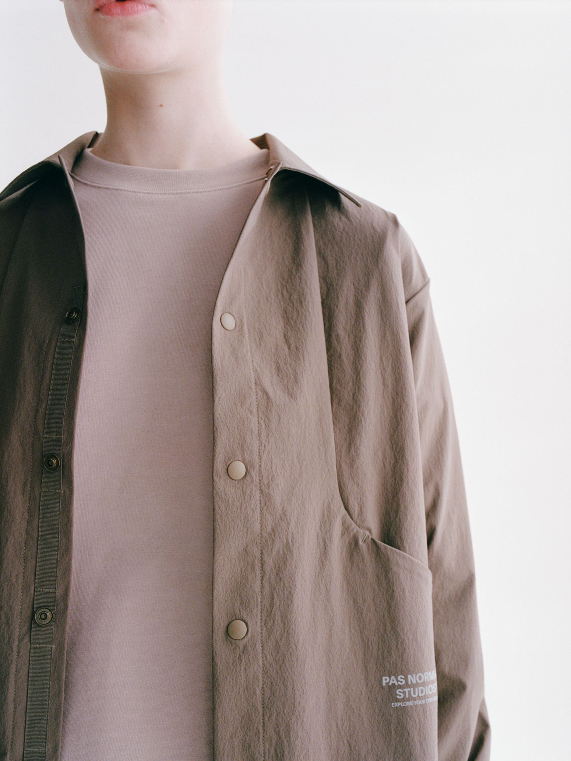 Ash Brown Off-Race Tech Overshirt on model with snap button closure and contrast green interior
