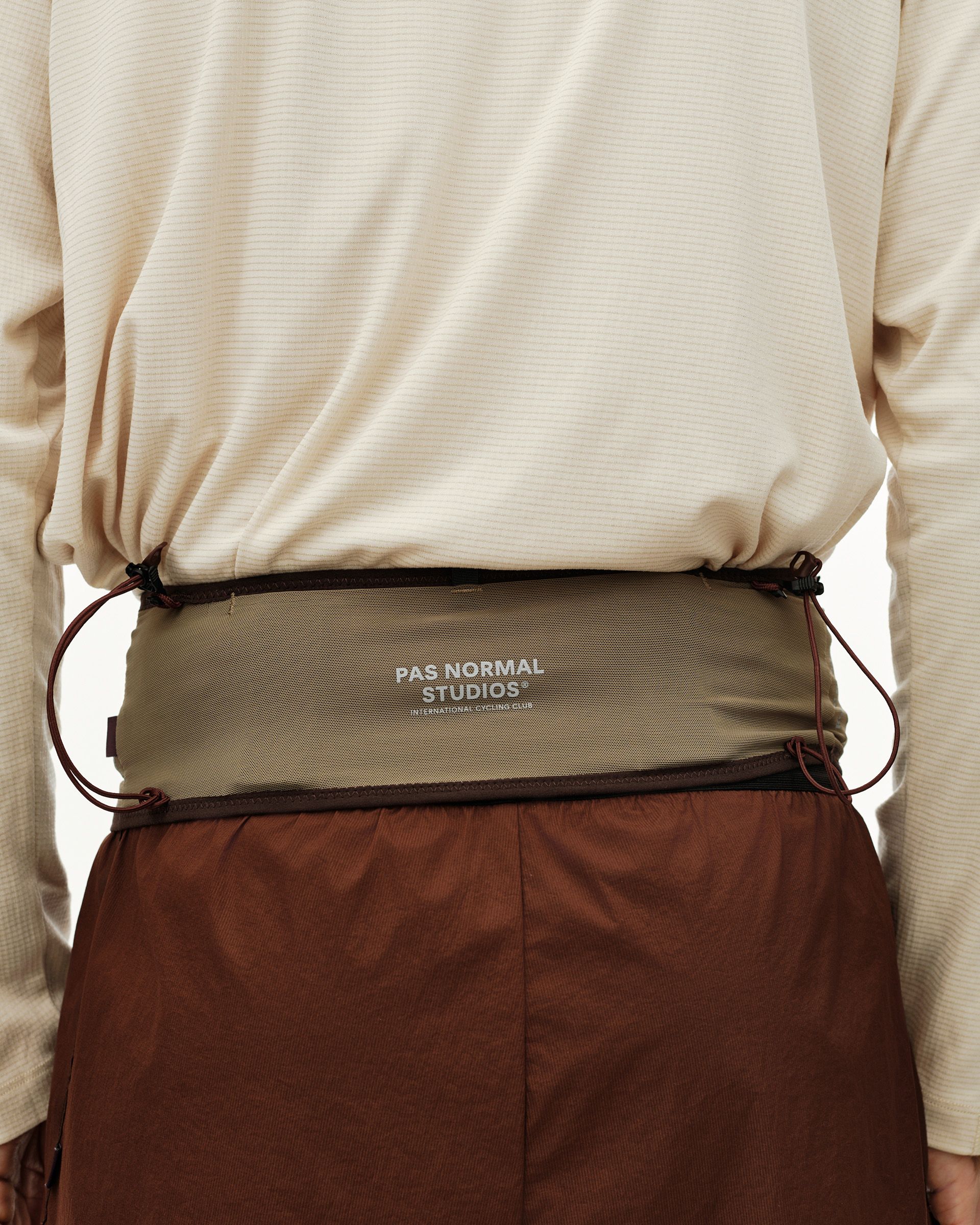 Light Brown Salomon S/LAB Belt worn on model, rear view with dark contrast trim and logo print