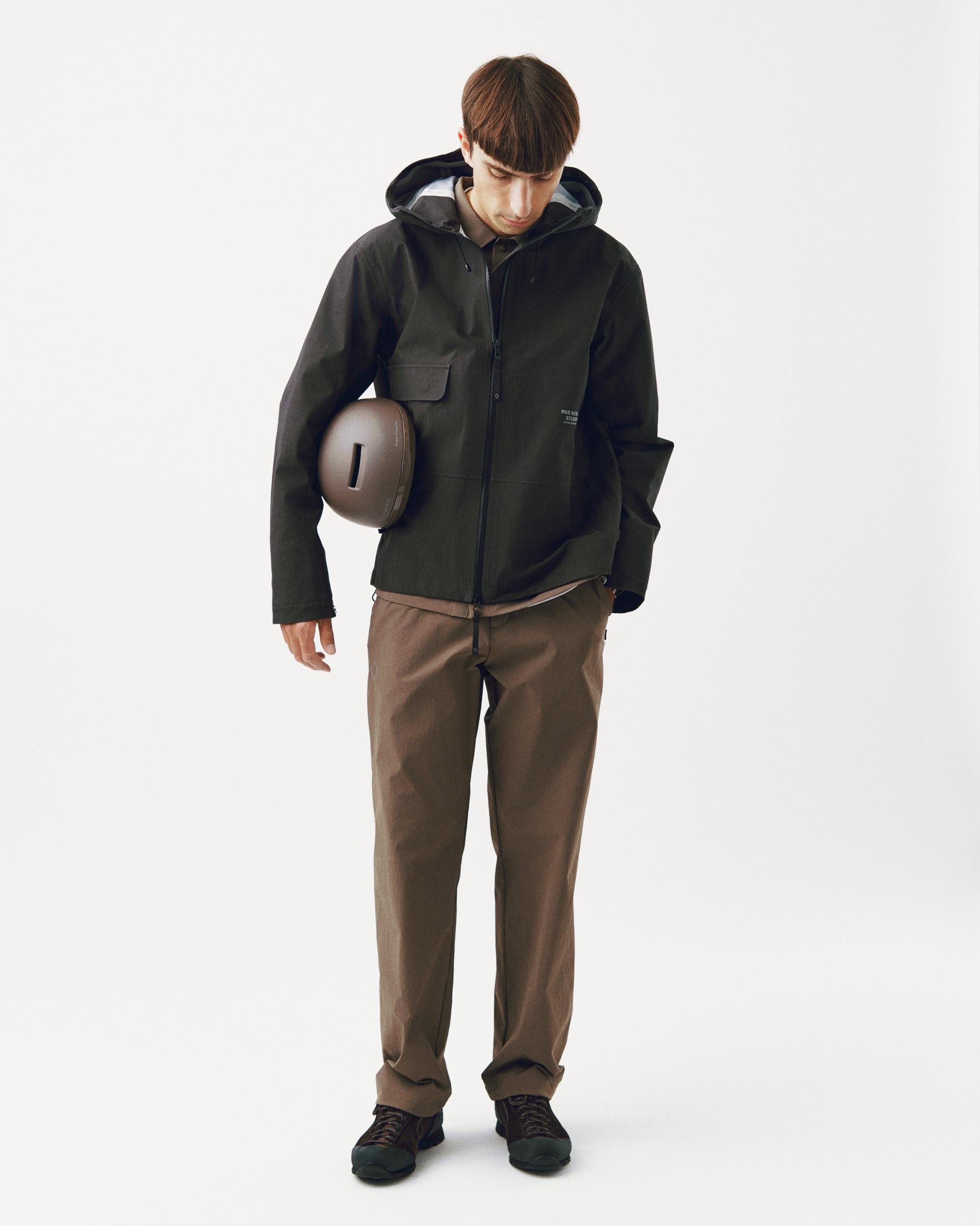 Dark Olive Off-Race 3L Cotton Shell jacket on model holding helmet with chest pocket