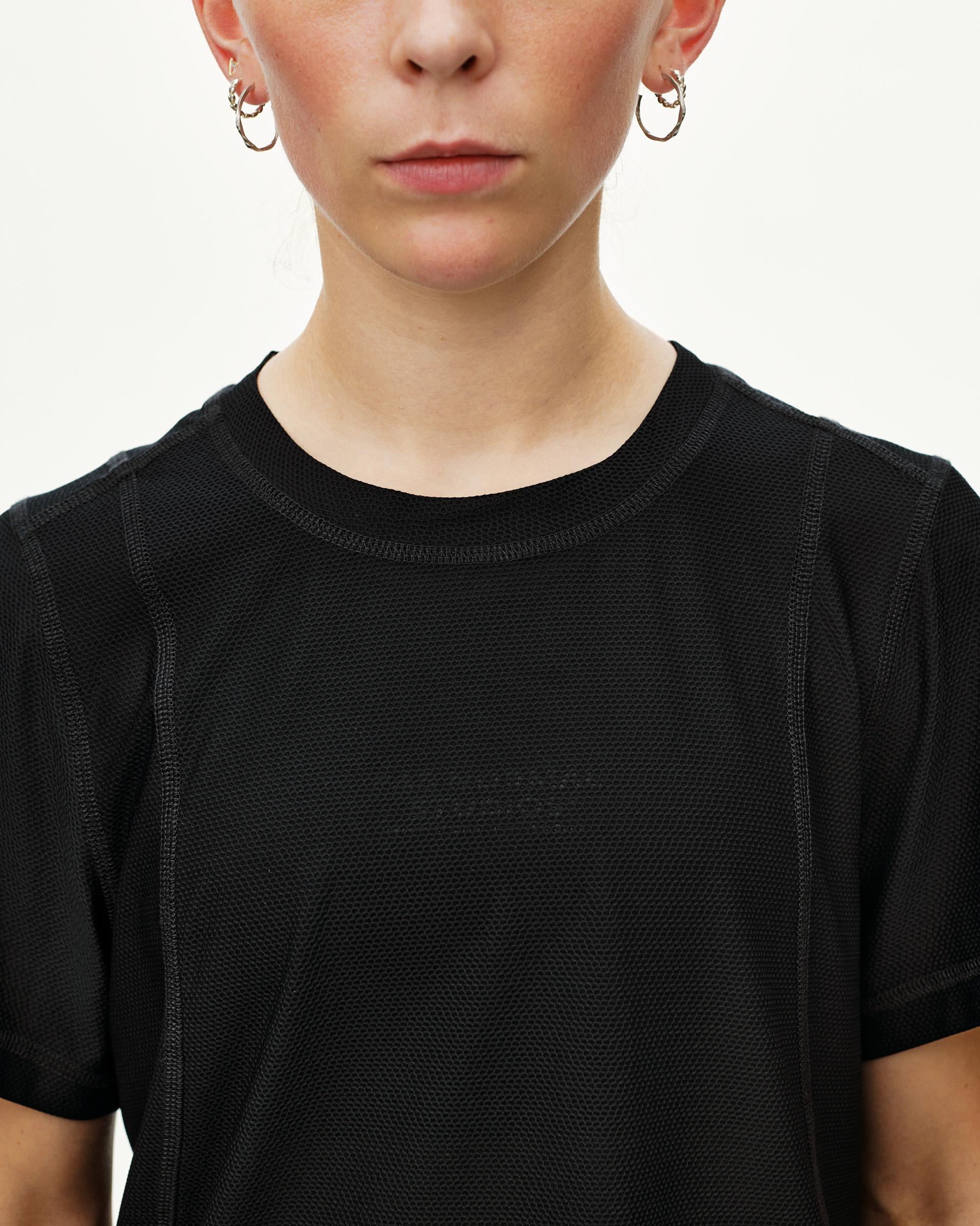 Black Balance T-Shirt on model, front detail view with textured mesh fabric and tonal chest print