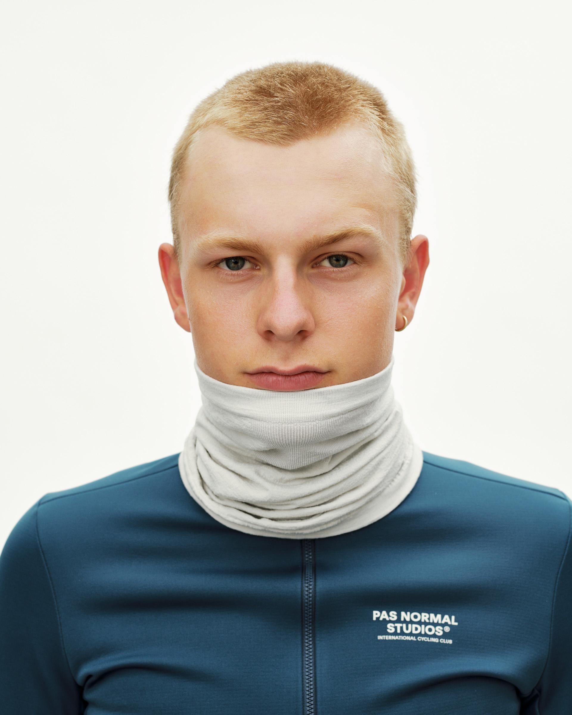 Misty Grey Essential Logo Merino Knit necktube on model, front view worn around neck and chin
