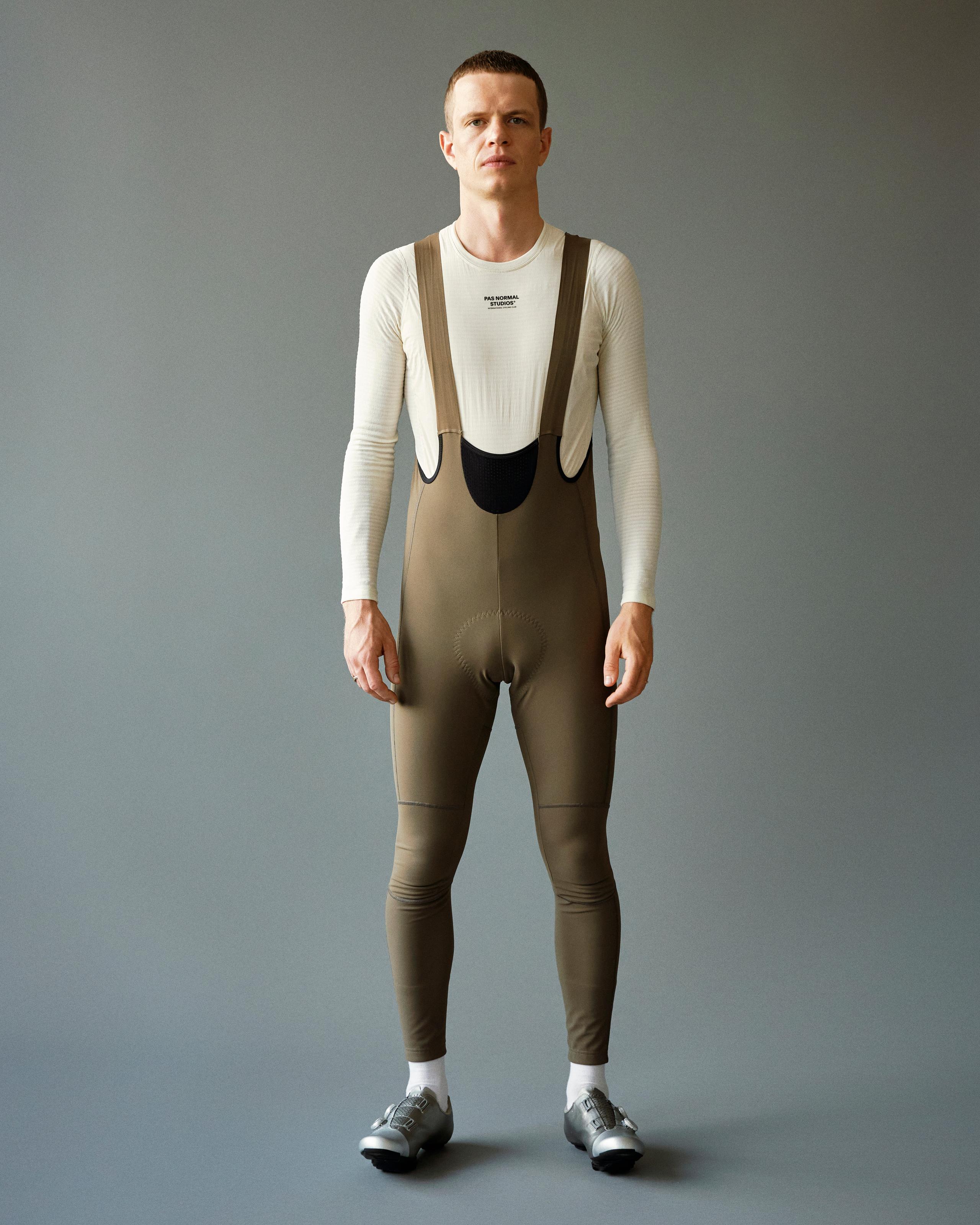 Dark Stone Mechanism Deep Winter Long cycling bibs on model with full-length legs and shoulder straps