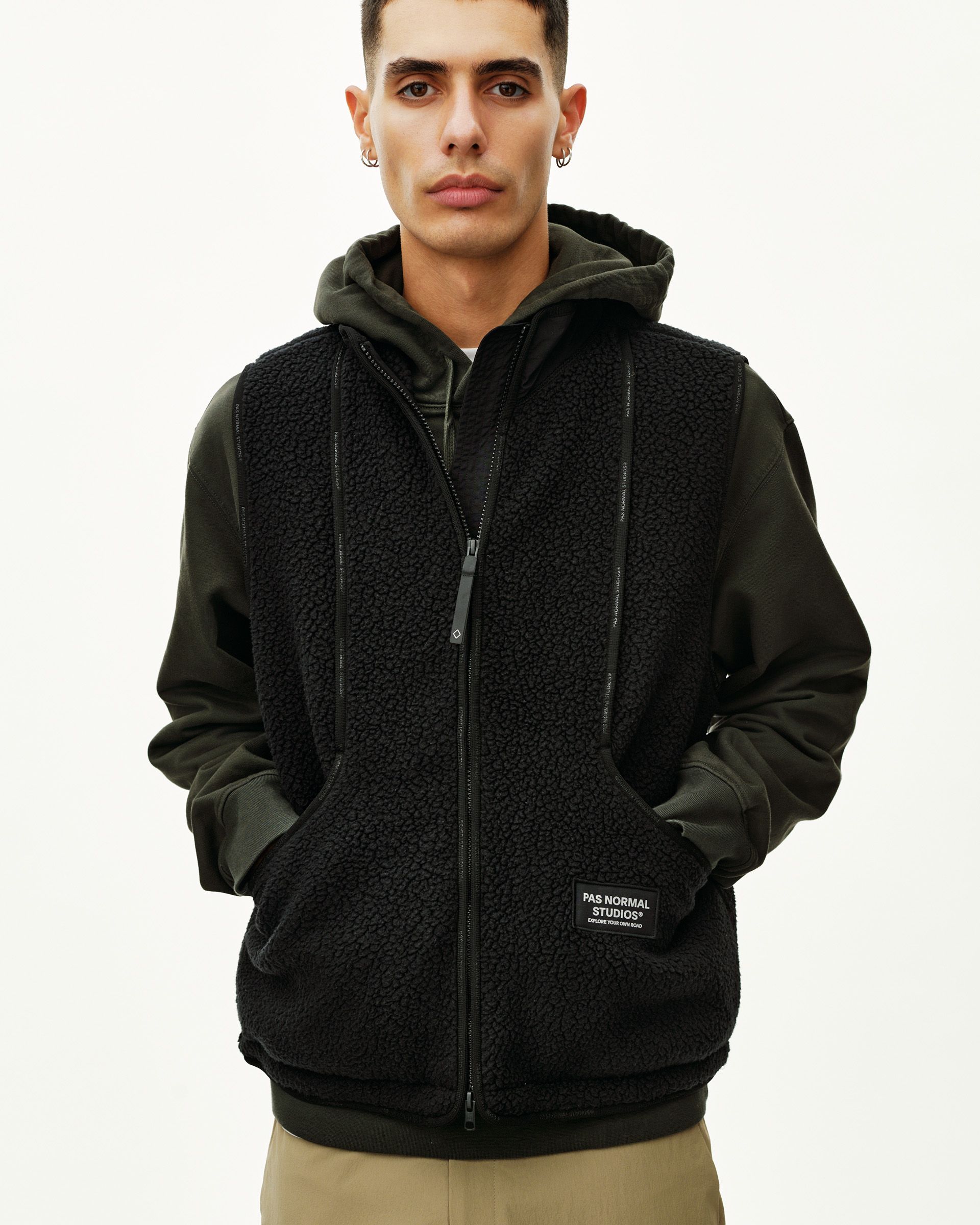 Black Off-Race Pile Fleece Vest on model, front view with full zip and branded patch