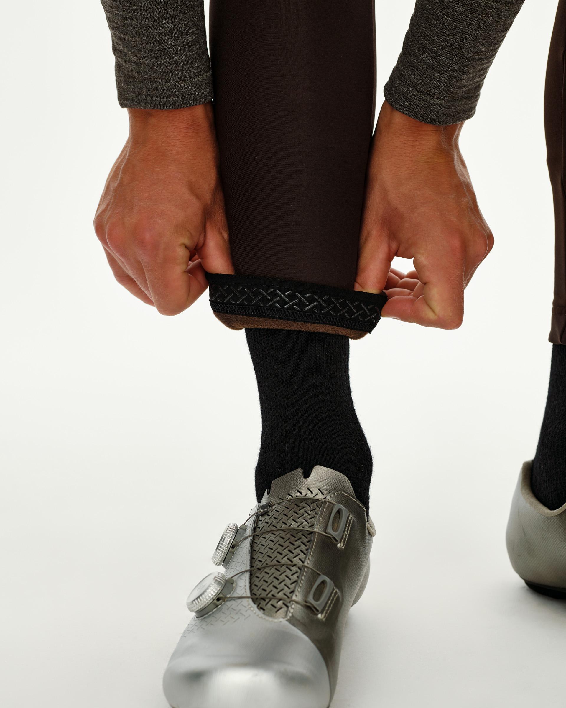 Dark Coffee Mechanism Thermal cycling bibs, detail view on model showing braided ankle gripper band