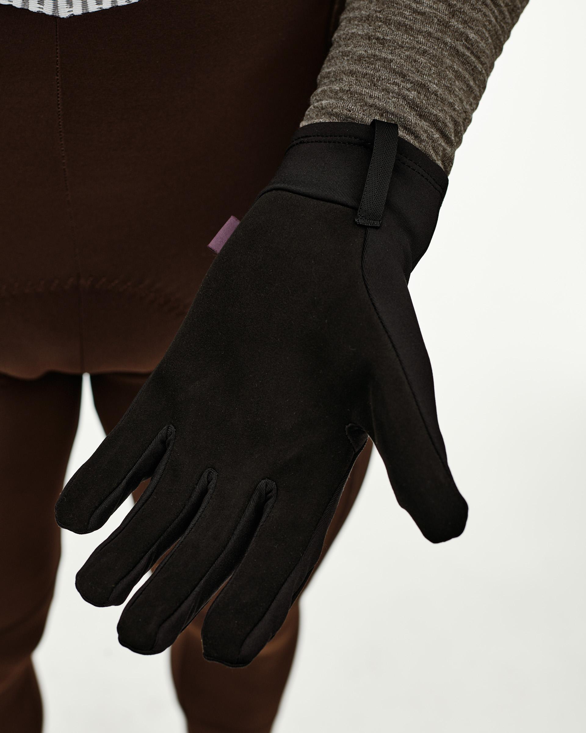 Black Logo Light cycling glove on model, palm-side detail view with pull tab at cuff