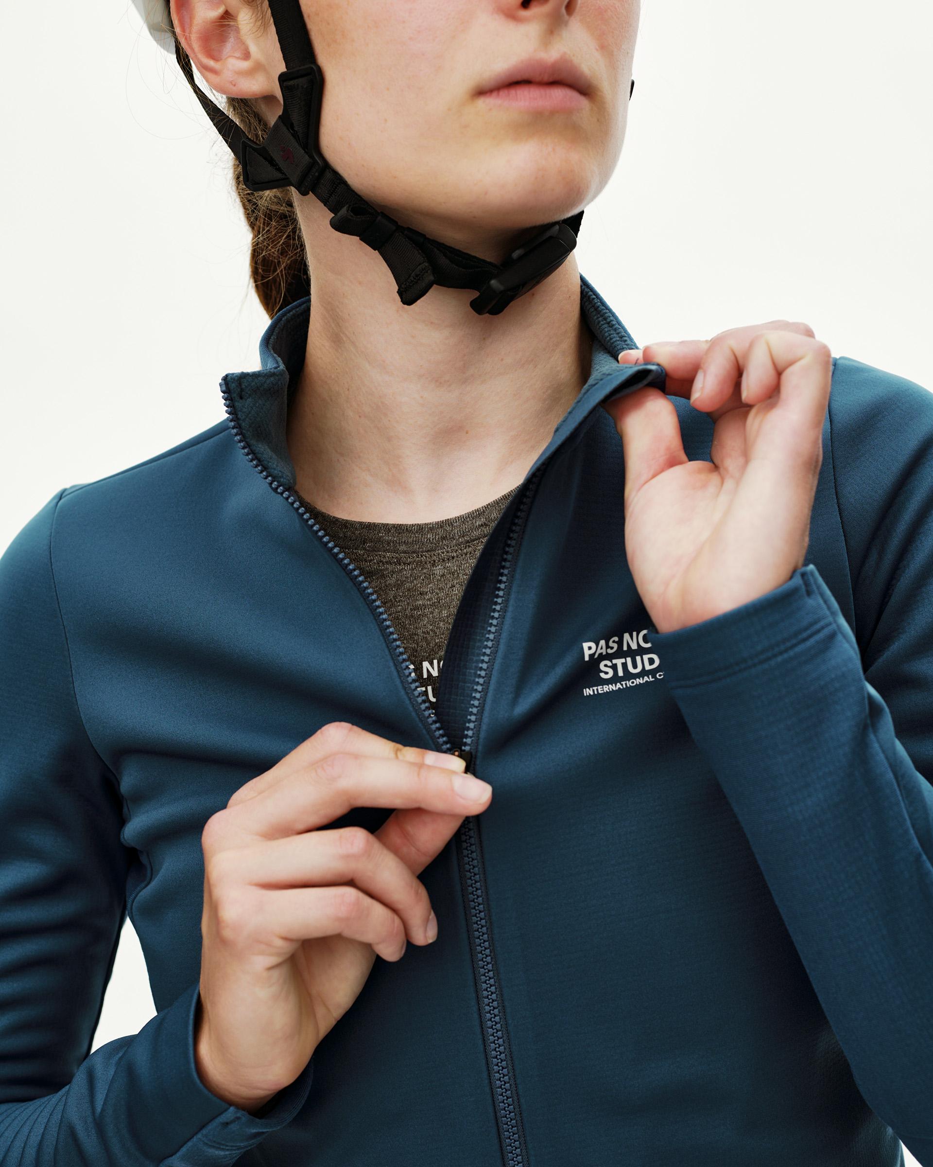 Denim Blue Mechanism Thermal Long Sleeve cycling jersey on model, front detail view with chest logo print