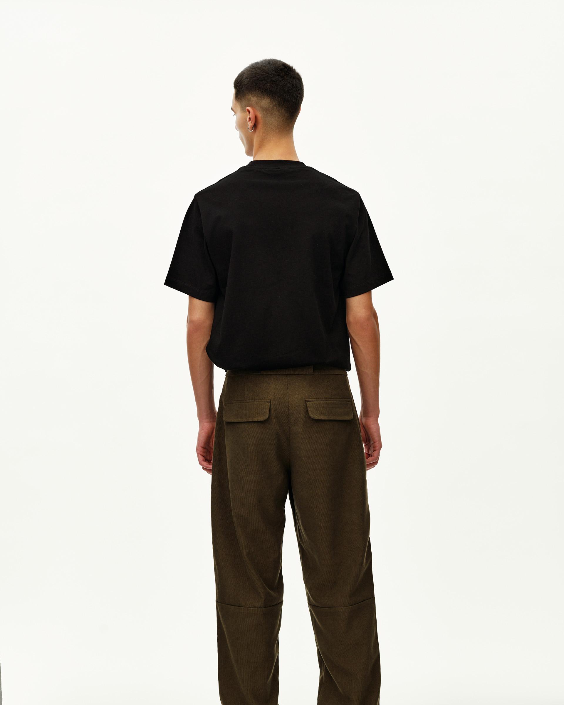 Deep Olive Off-Race Corduroy pants on model, rear view with patch pockets