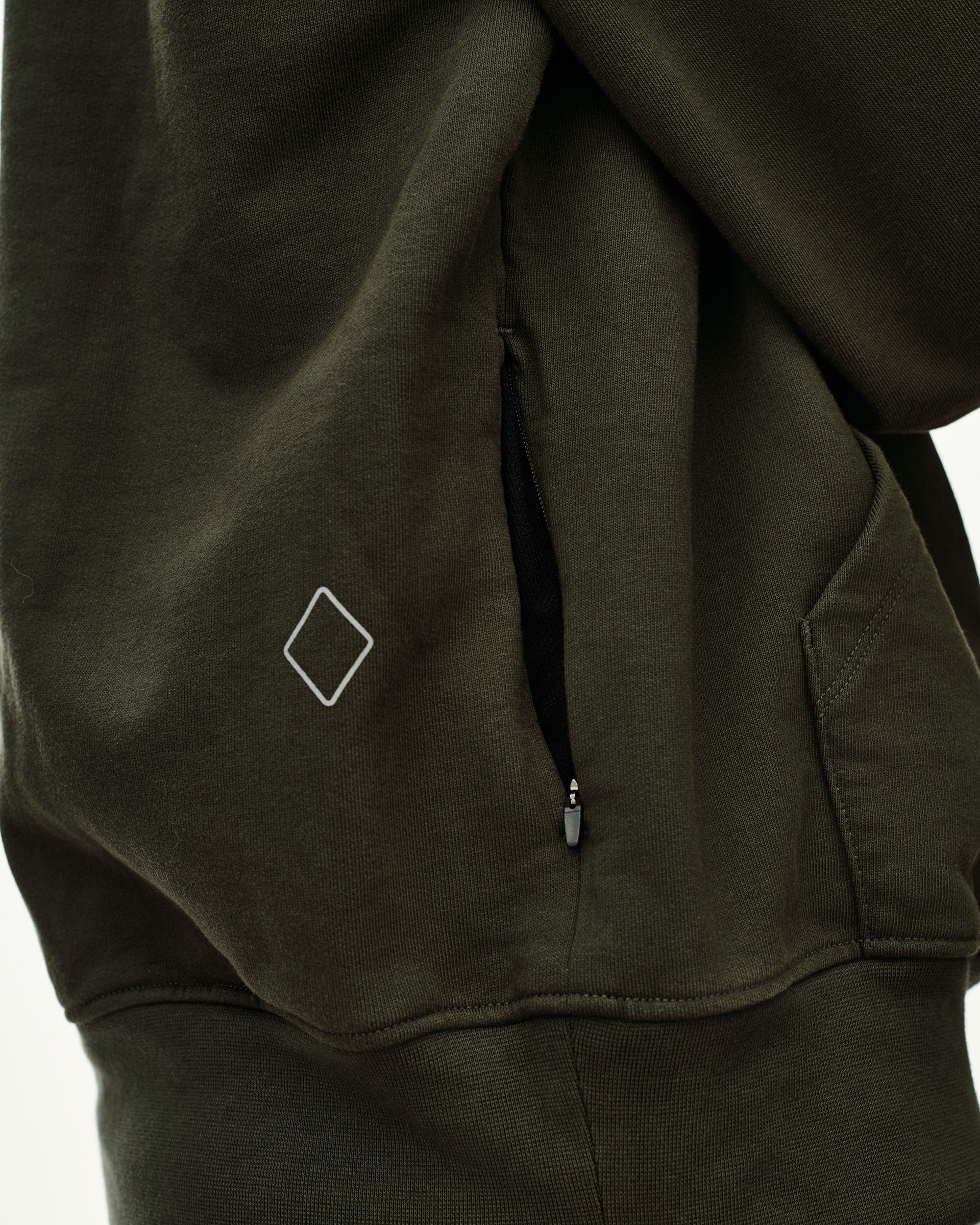 Dark Olive Off-Race hoodie, detail view of side zip pocket and diamond logo patch