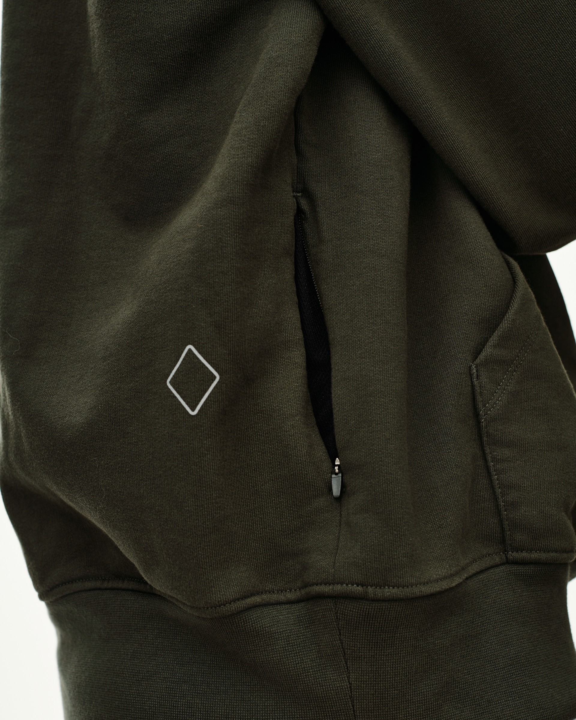 Dark Olive Off-Race hoodie, detail view of side zip pocket and diamond logo patch