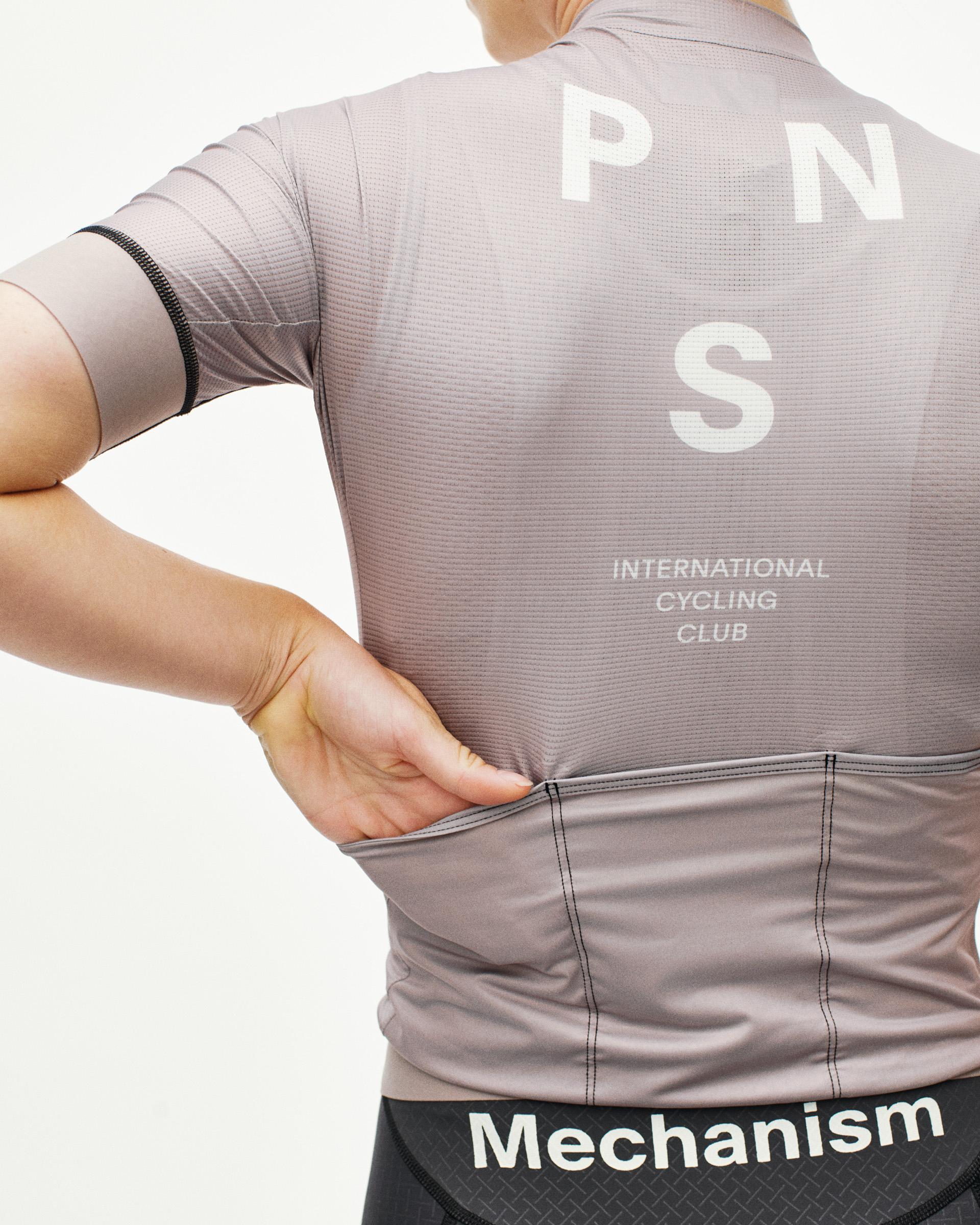 Grey Mechanism cycling jersey on model, rear view with white PNS logo and contrast stitching
