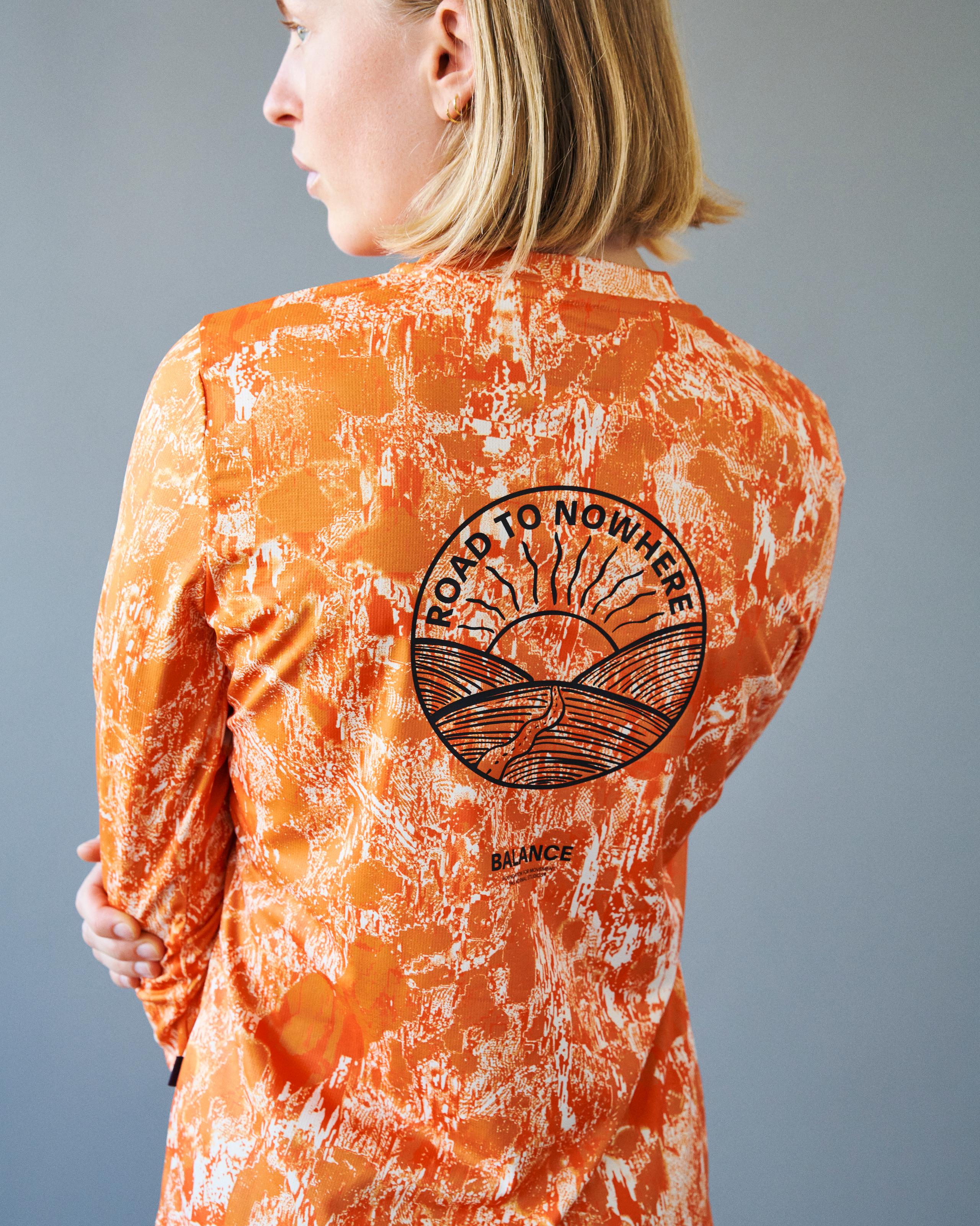 Orange Balance long sleeve t-shirt on model, rear view with Road to Nowhere circular back print