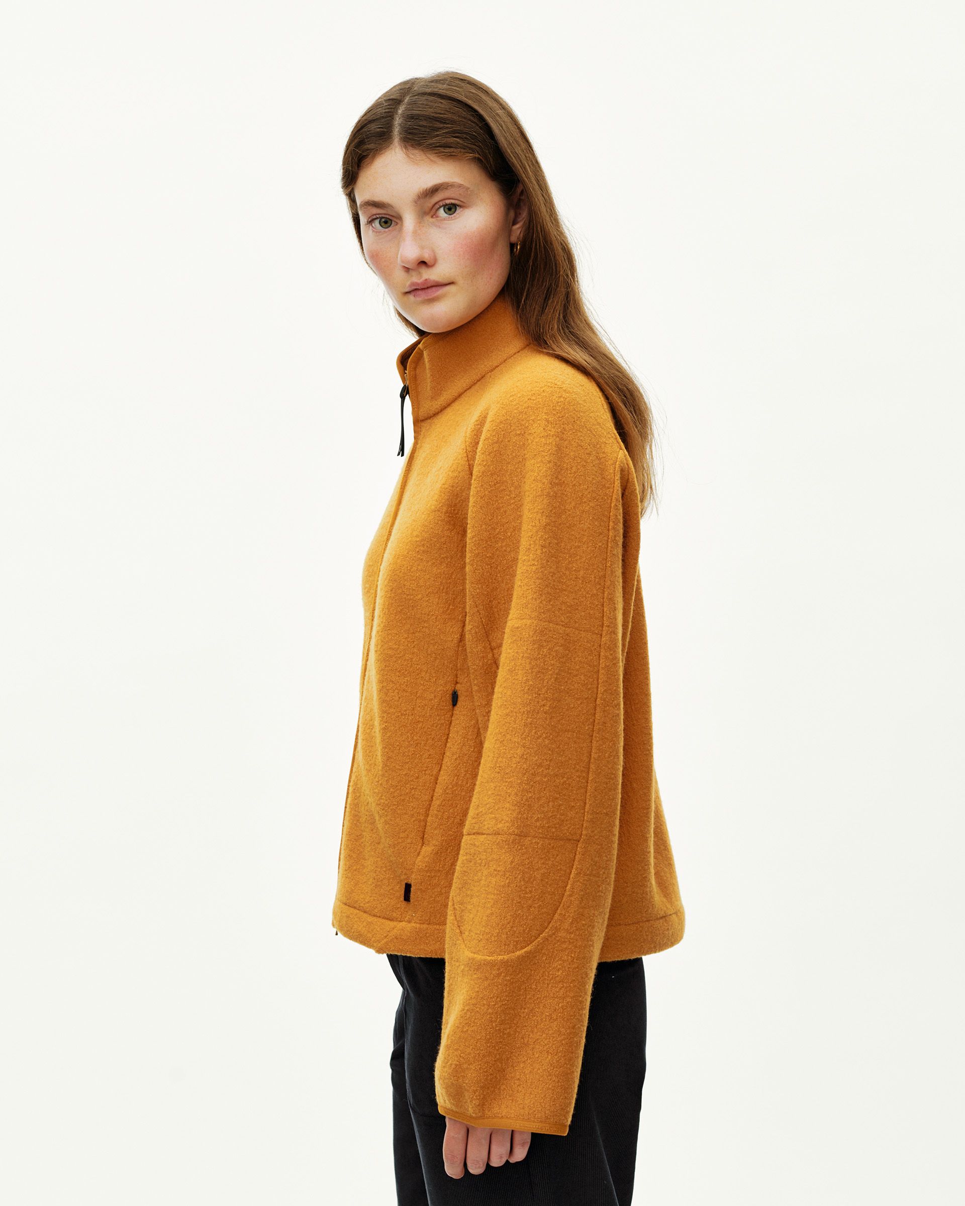 Ochre Off-Race Boiled Wool jacket on model, side view with mock neck and patch pockets