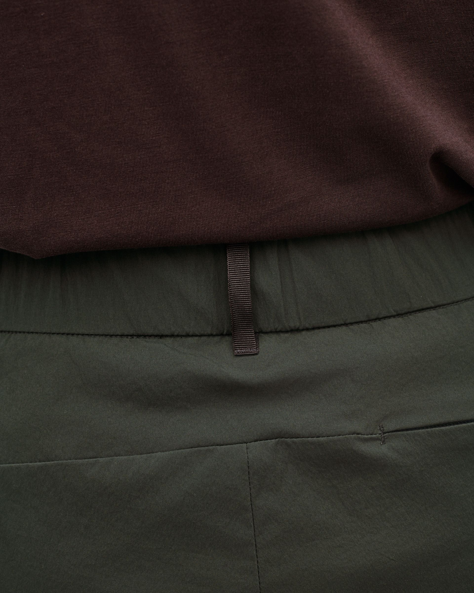 Dark Grey Off-Race Light Tech shorts, detail view showing waistband with brown woven label