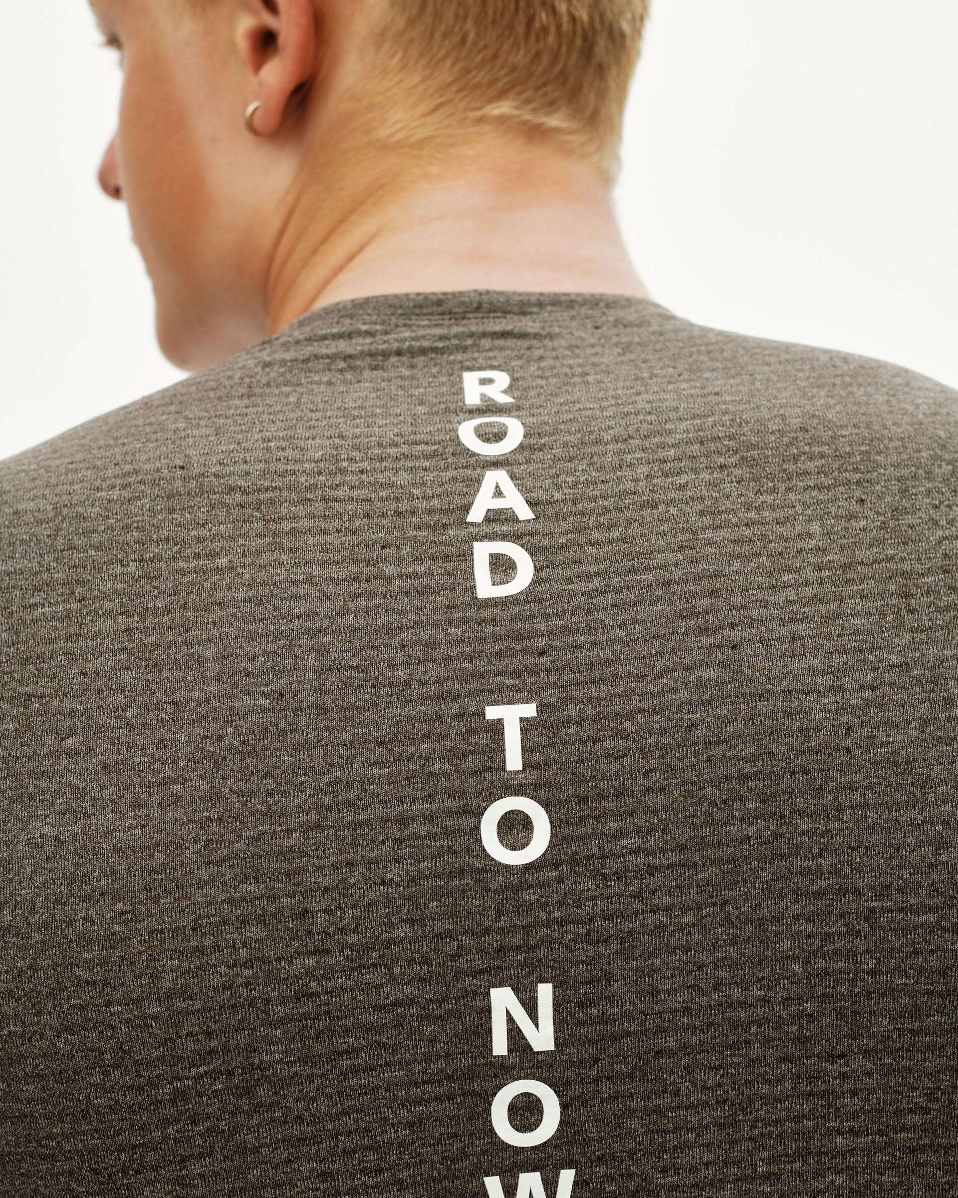 Dark Coffee brown Essential cycling base layer, rear detail on model with vertical white text print