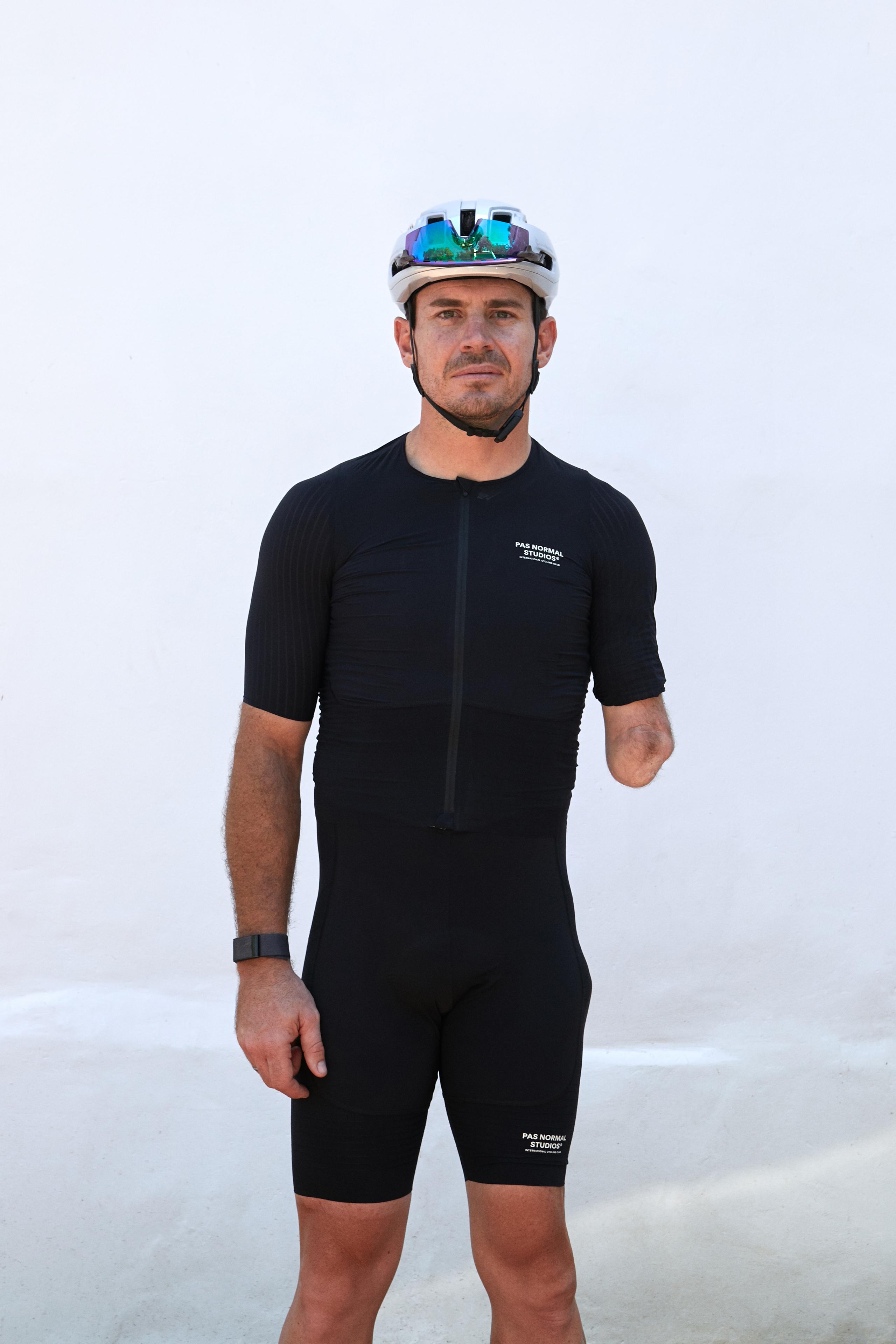 Black Mechanism bibs on model, front view with white chest logo