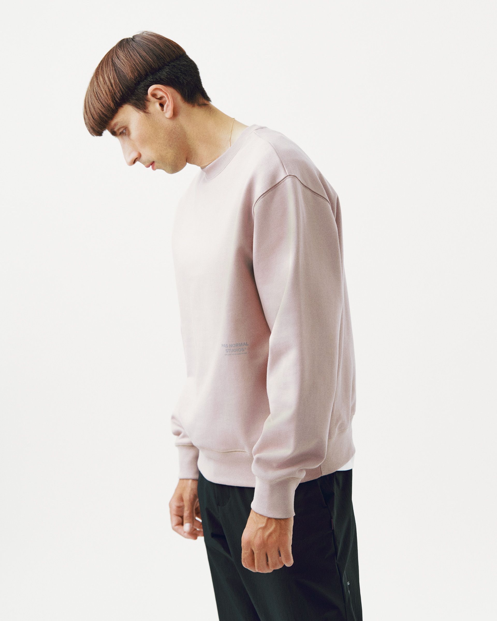Pink Off-Race sweatshirt on model, side view with ribbed cuffs and hem