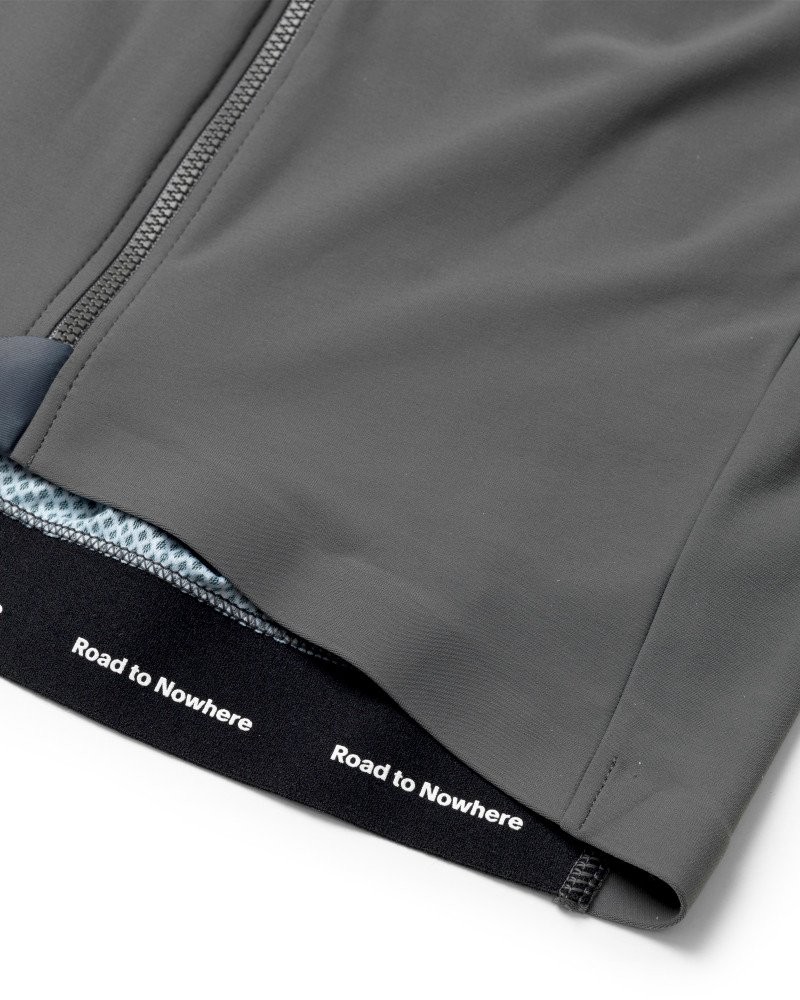Grey Mechanism long sleeve cycling jersey, detail view with white mesh inner hem and Road to Nowhere print
