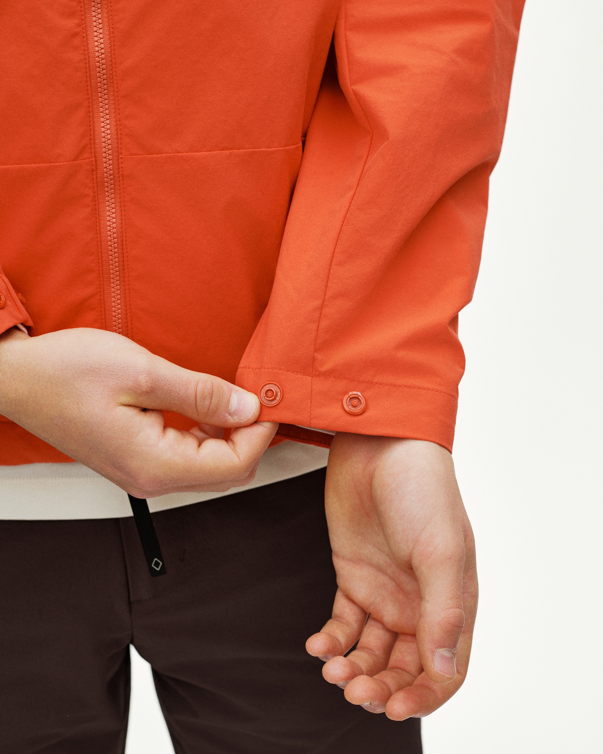 Orange Off-Race Utility jacket on model showing snap button cuff detail