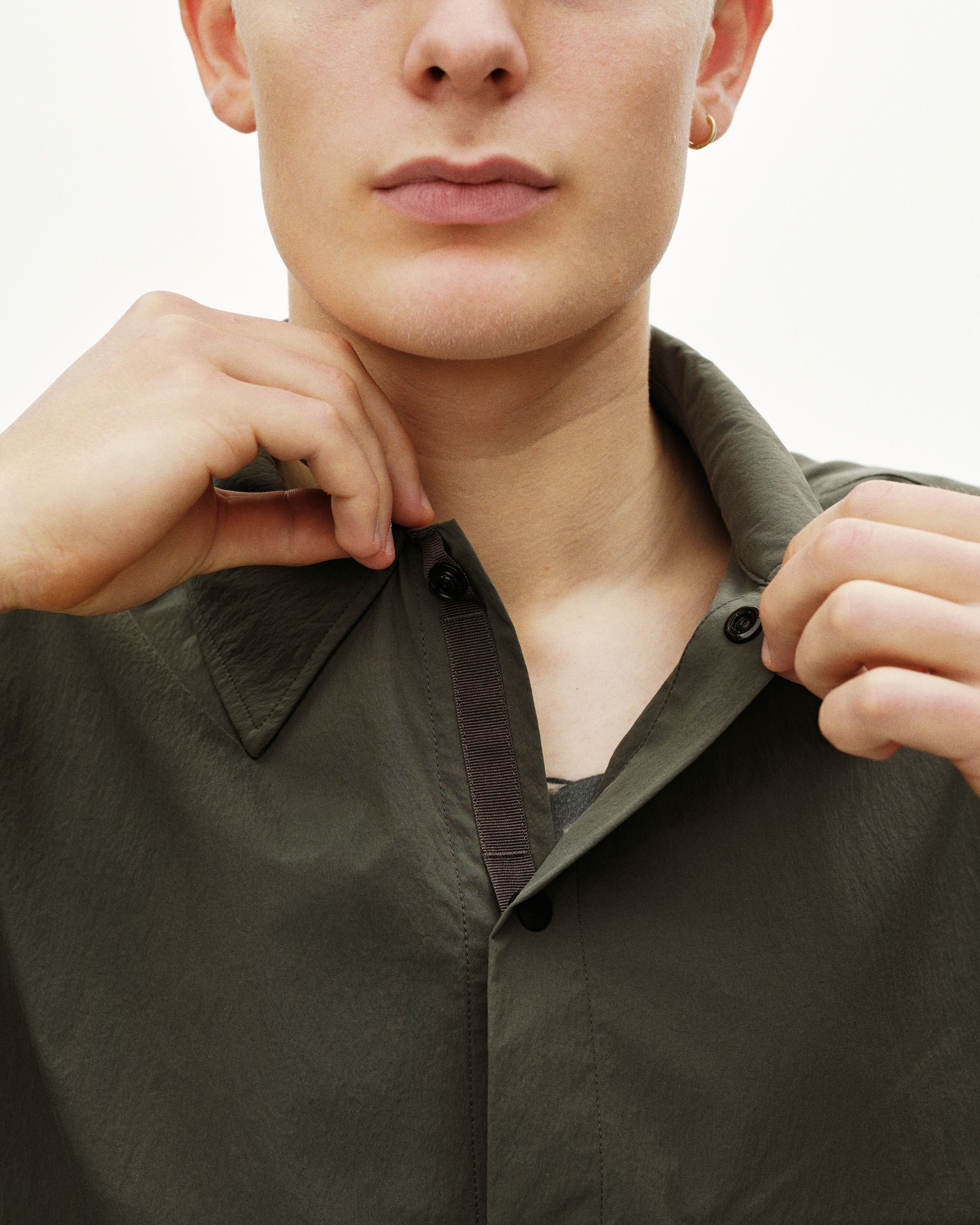 Dark Grey Off-Race Light Tech shirt on model with ribbed collar detail