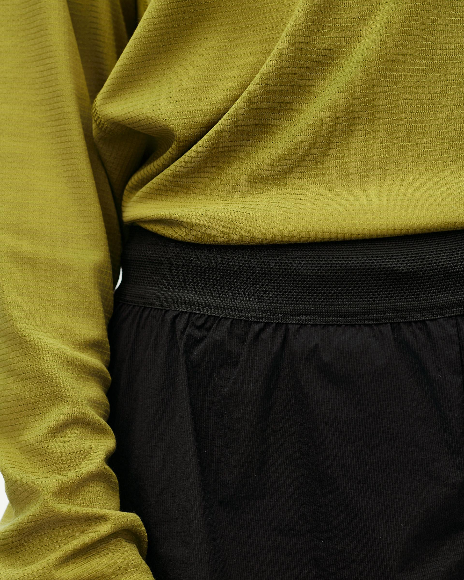 Black Balance 2-in-1 shorts, waistband detail on model with olive green top