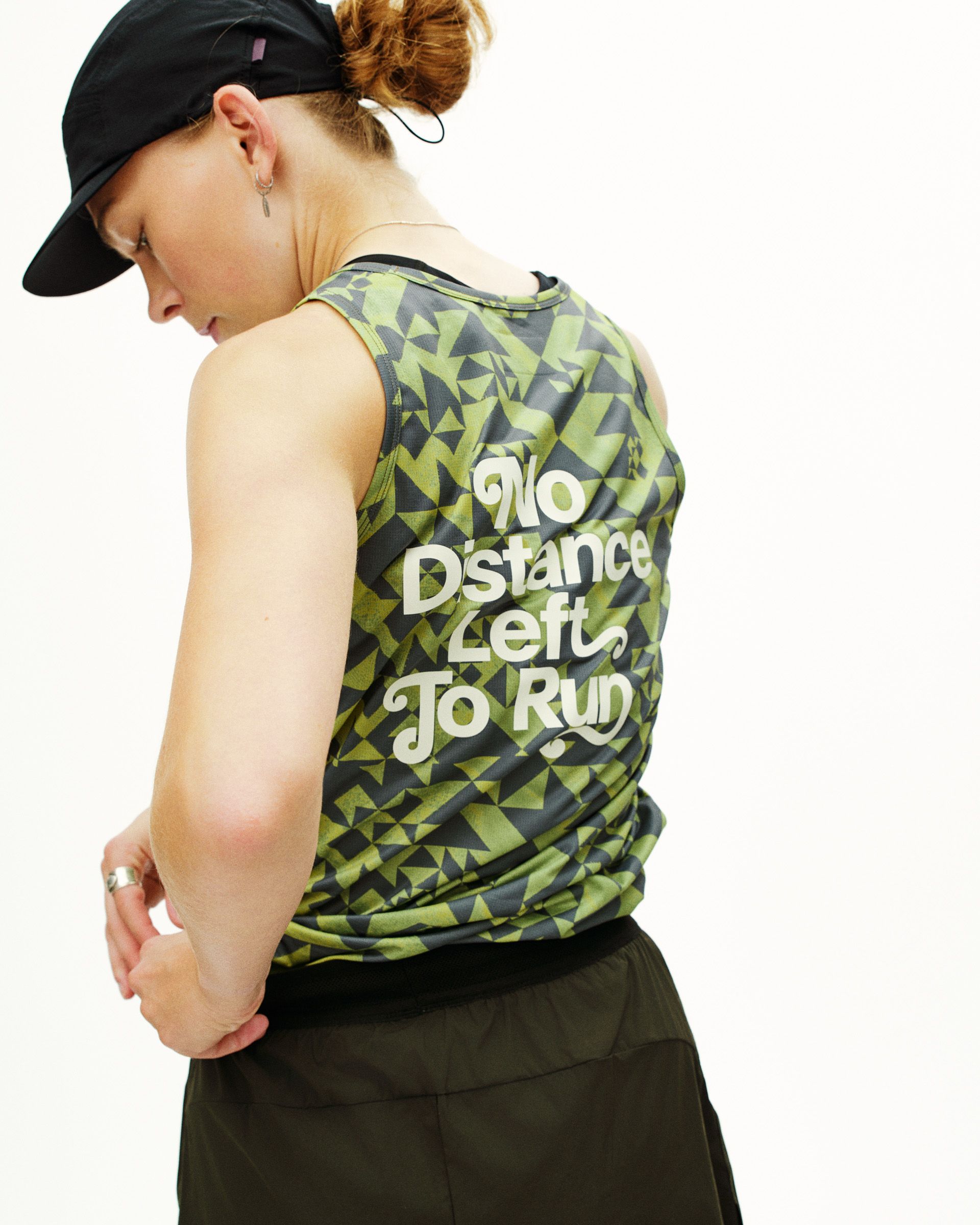Green Balance singlet on model showing geometric pattern and white text print