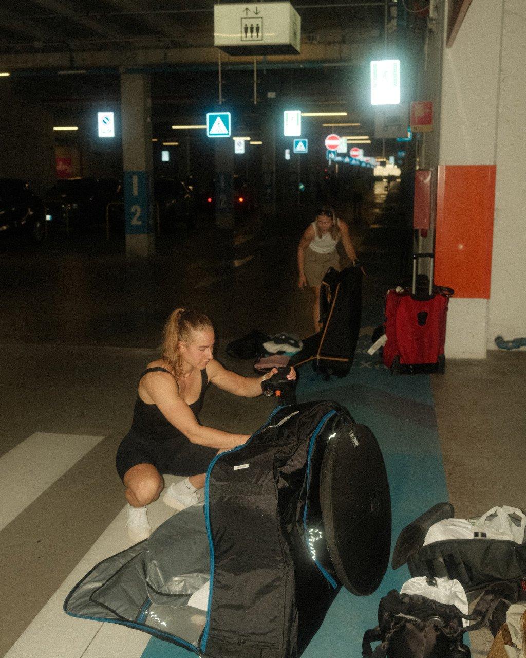 Cyclist packing bike bag in underground garage after travel