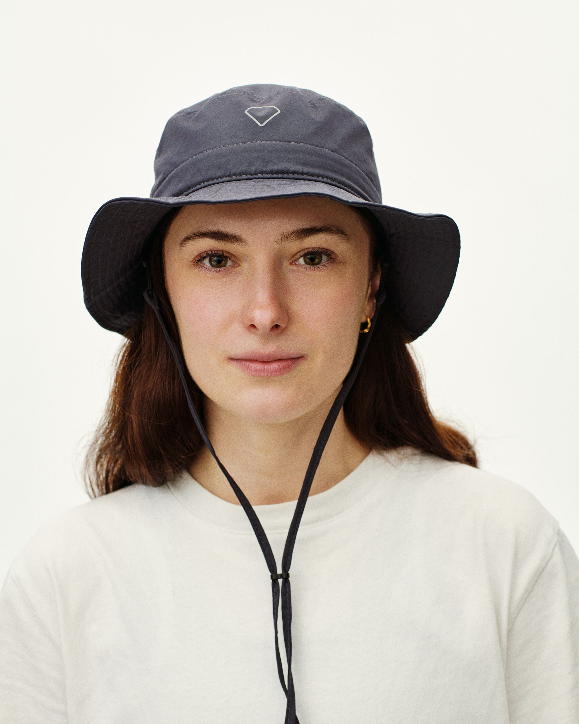 Grey Off-Race Tech bucket hat on model with chin strap and white logo
