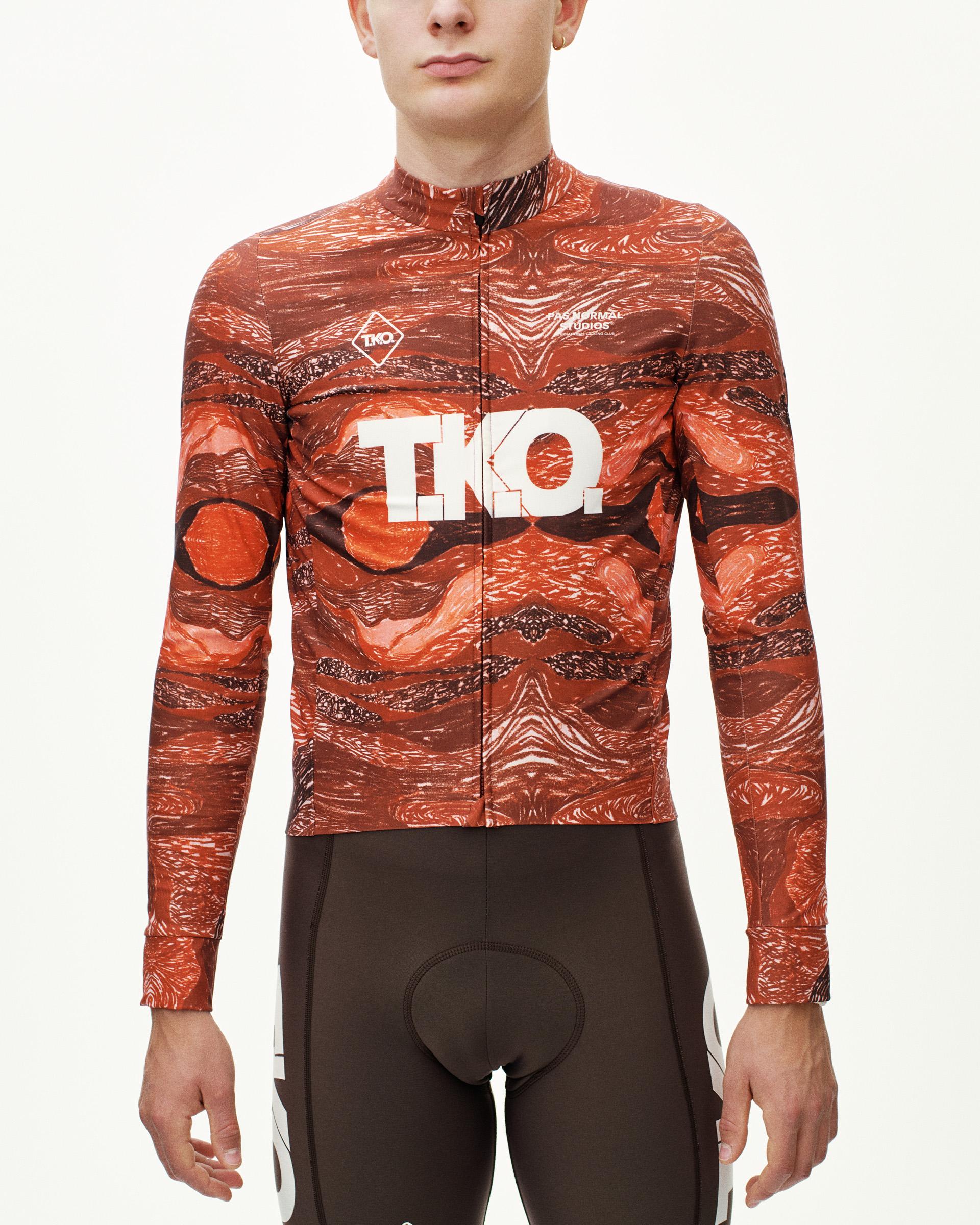 Red T.K.O. long sleeve cycling jersey on model, front view with all-over woven print and white chest logo