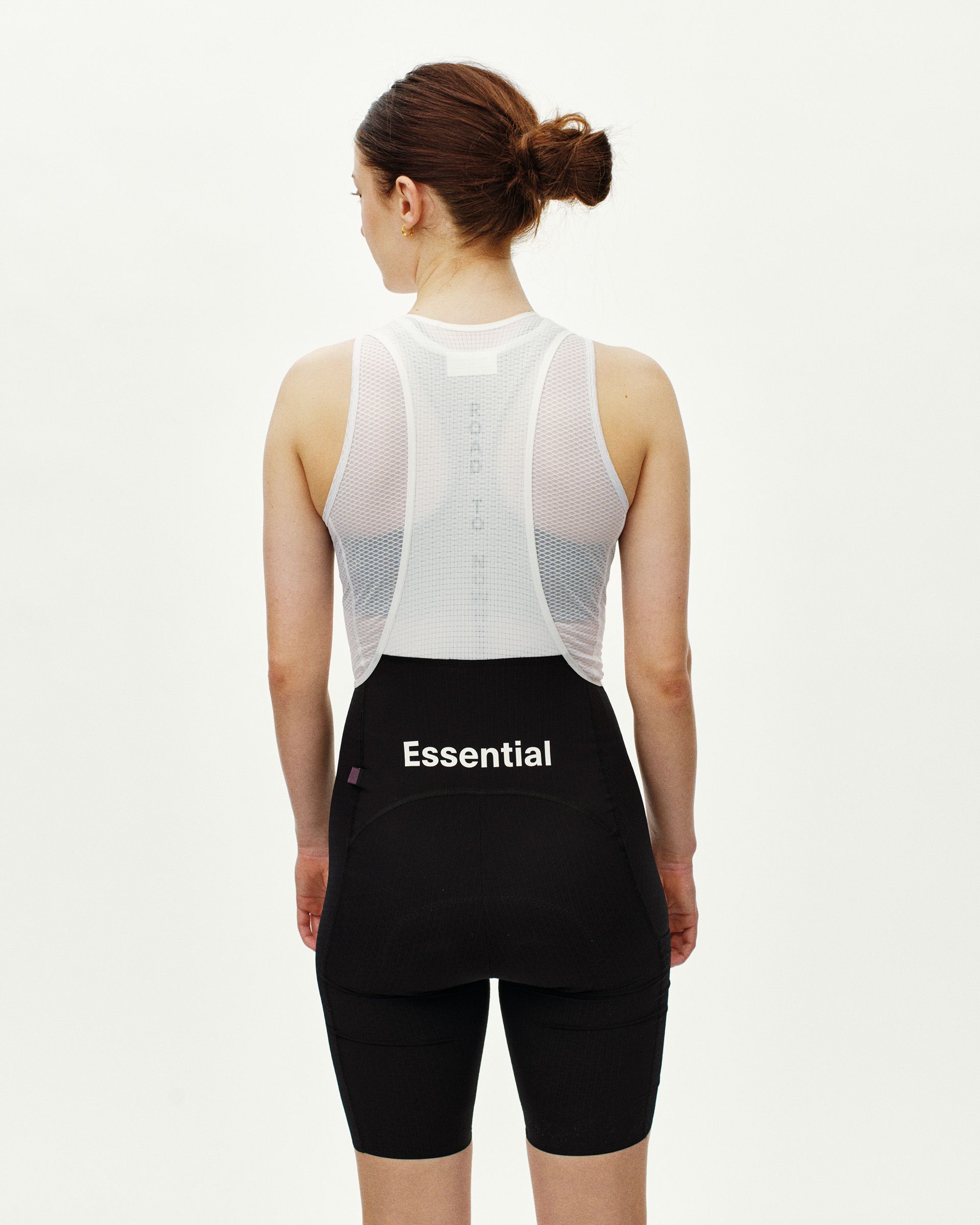 Black Essential Light Cargo cycling bibs on model, rear view with mesh back panel and cargo pocket