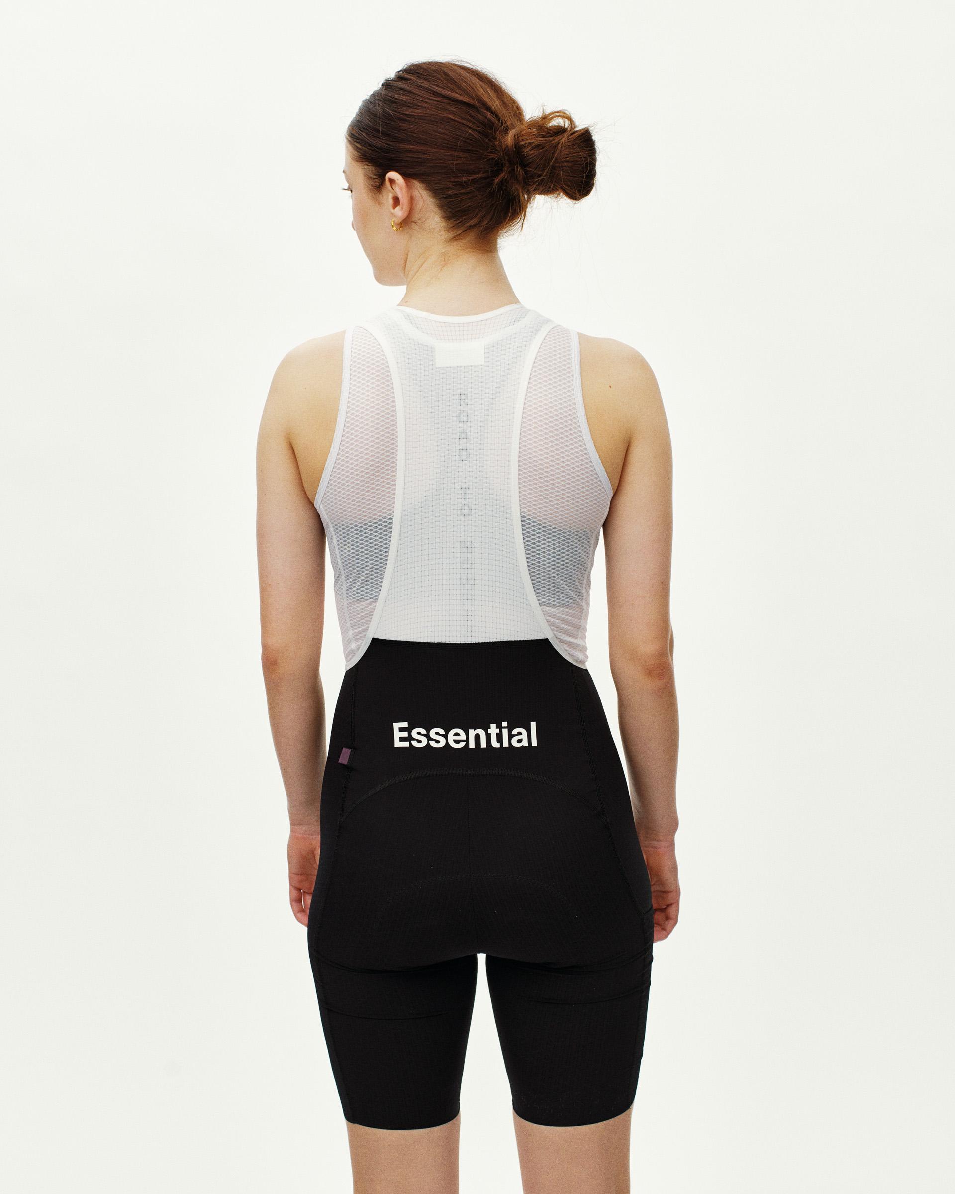 Black Essential Light Cargo cycling bibs on model, rear view with mesh back panel and cargo pocket