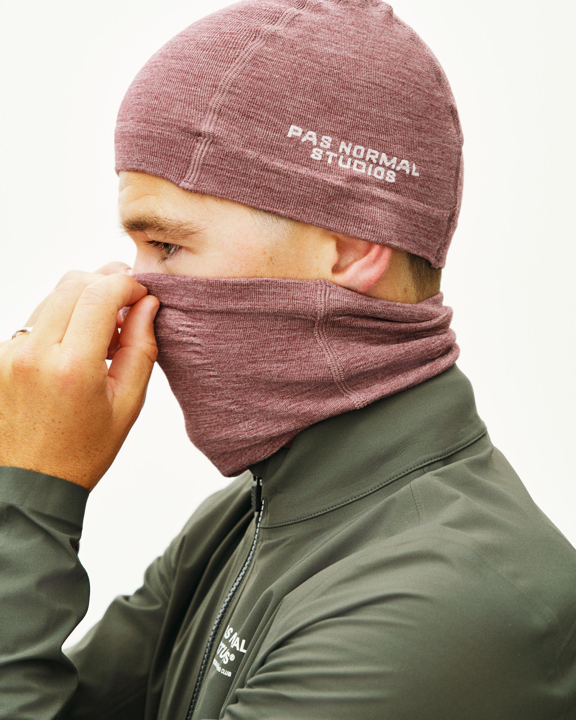 Maroon Logo Merino Knit beanie on model with white text branding