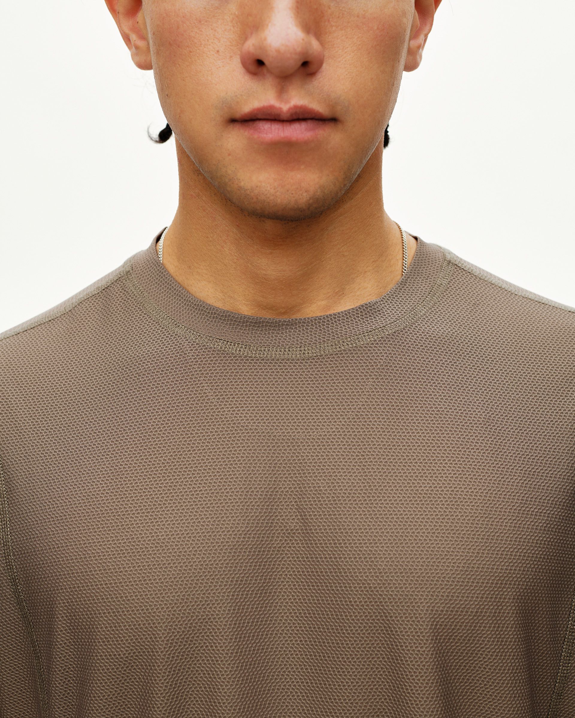 Stone Brown Balance T-shirt on model, front detail view with textured mesh fabric and ribbed crew neck