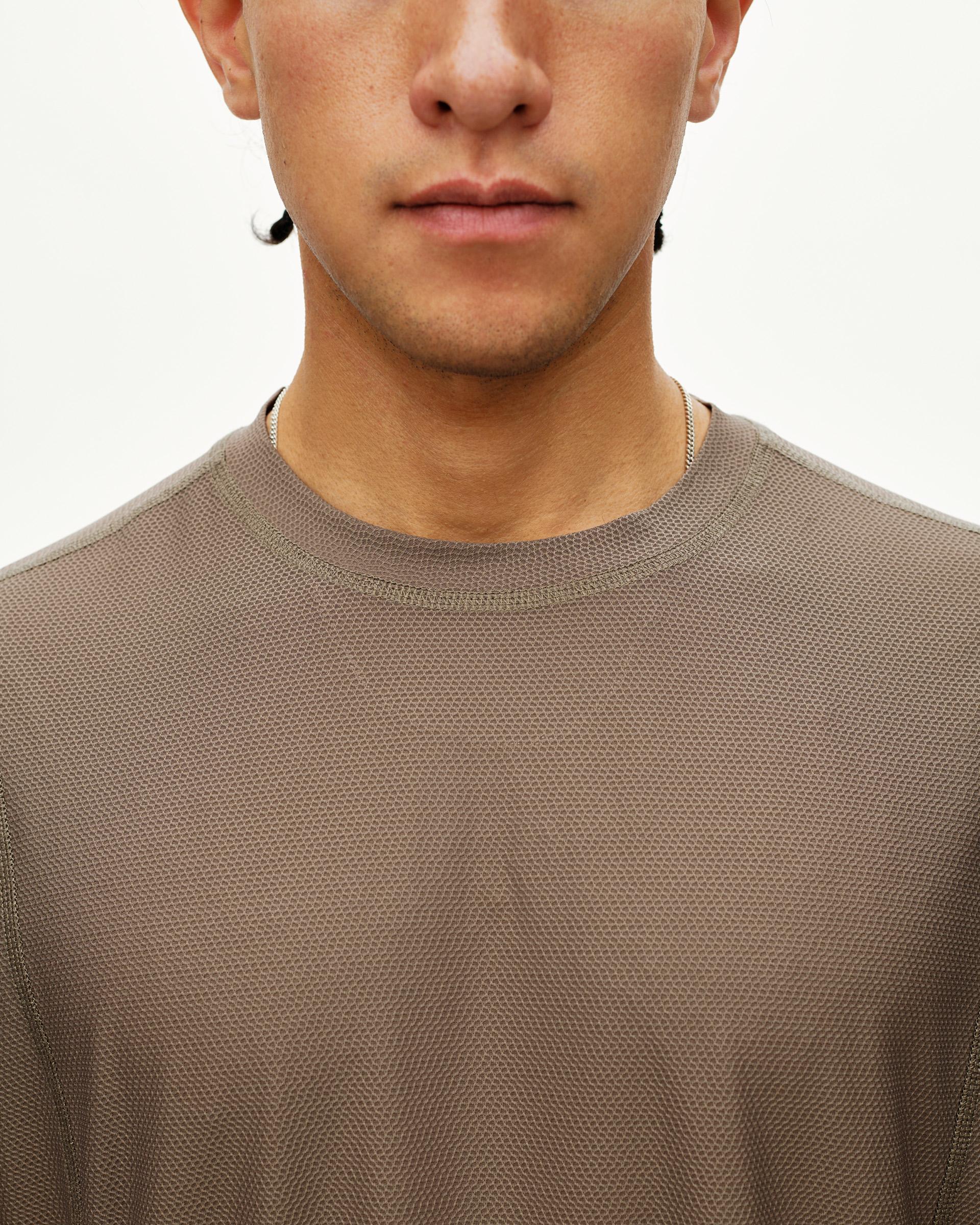 Stone Brown Balance T-shirt on model, front detail view with textured mesh fabric and ribbed crew neck