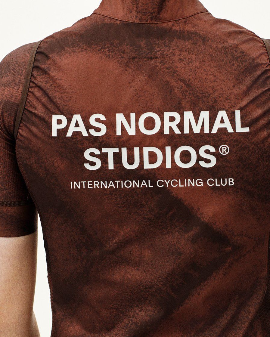 Brown Mechanism Stow Away gilet, rear view on model with white logo print