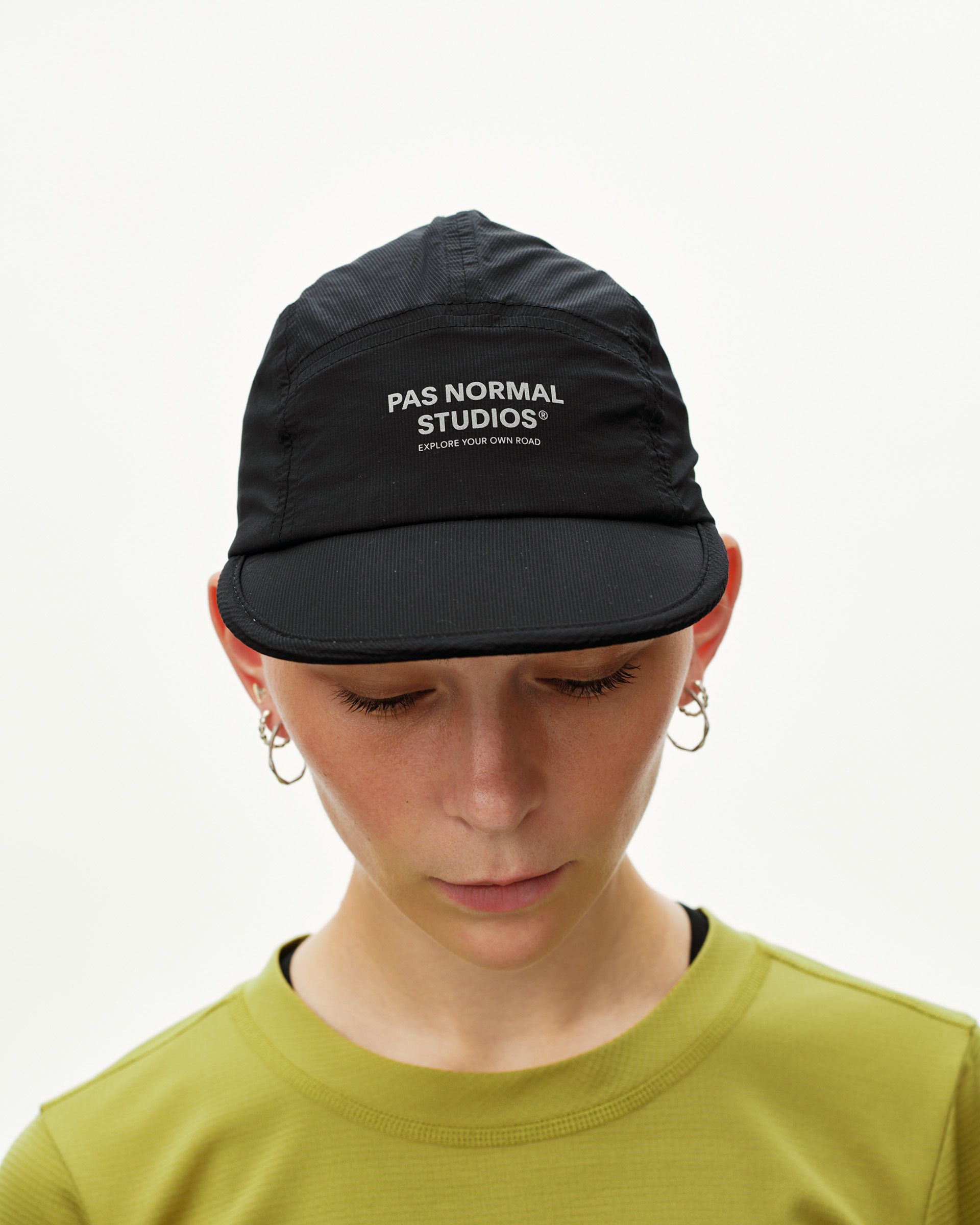 Black Balance cycling cap on model, front view with white logo print