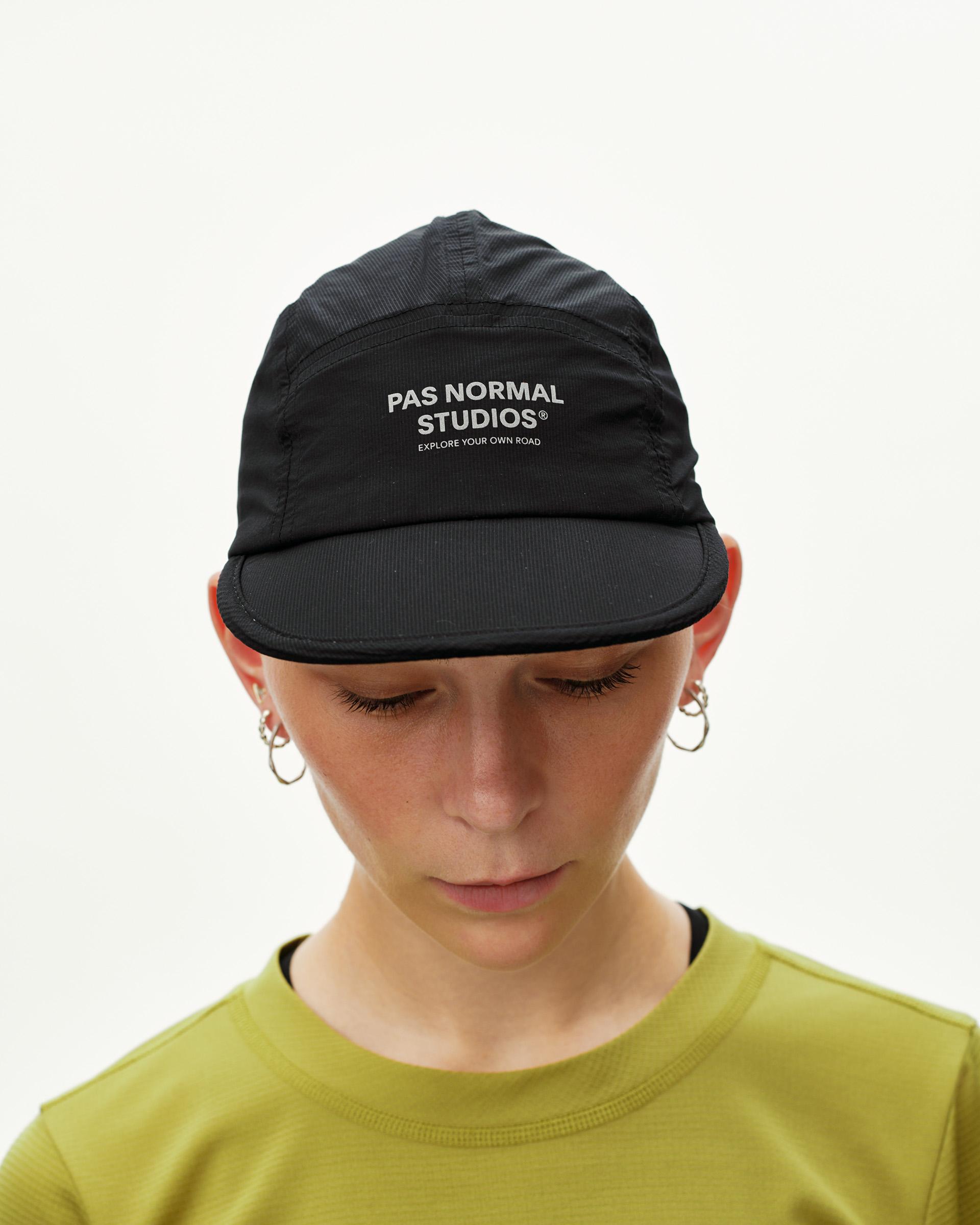Black Balance cycling cap on model, front view with white logo print