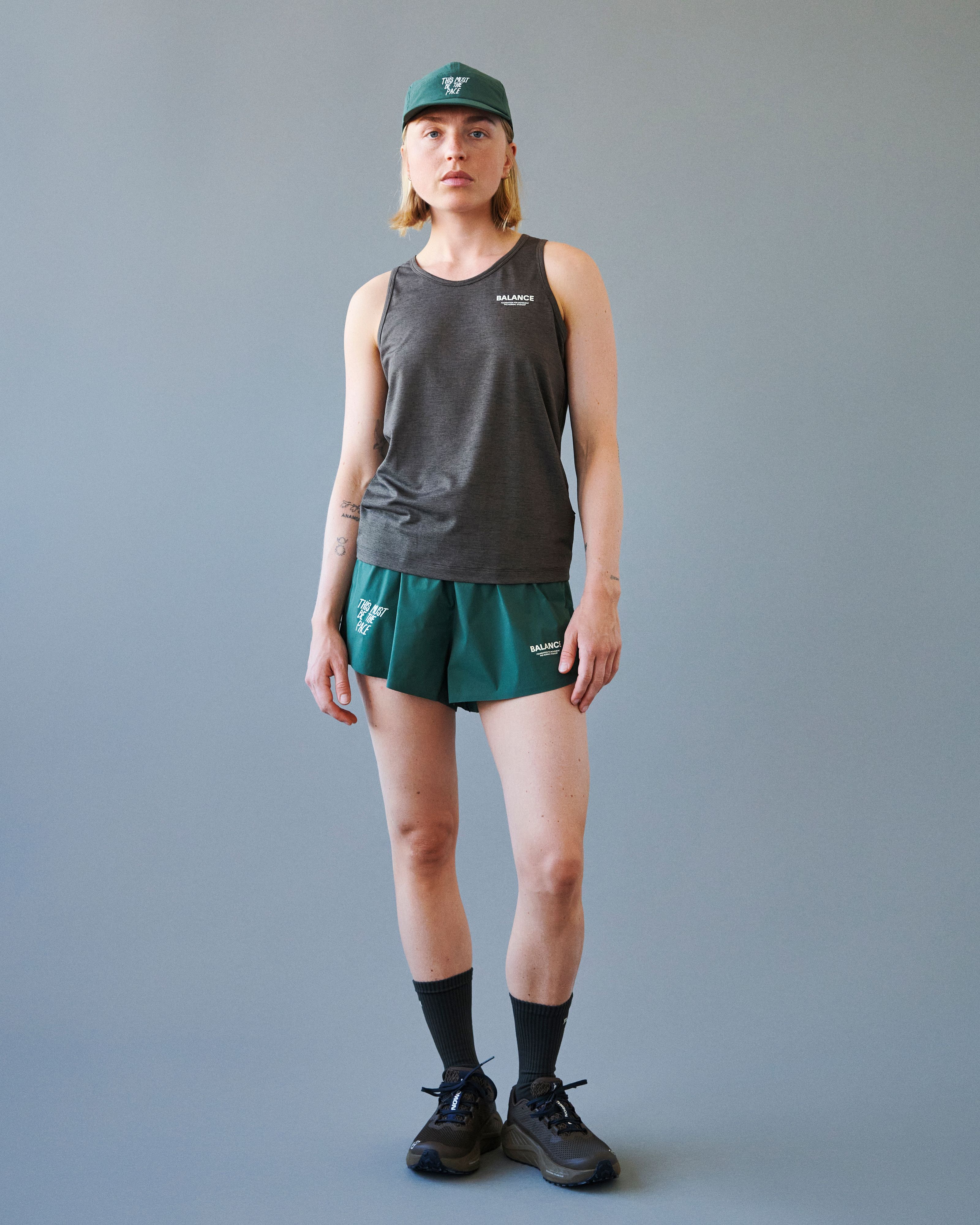 Brown Balance singlet on model with white chest print
