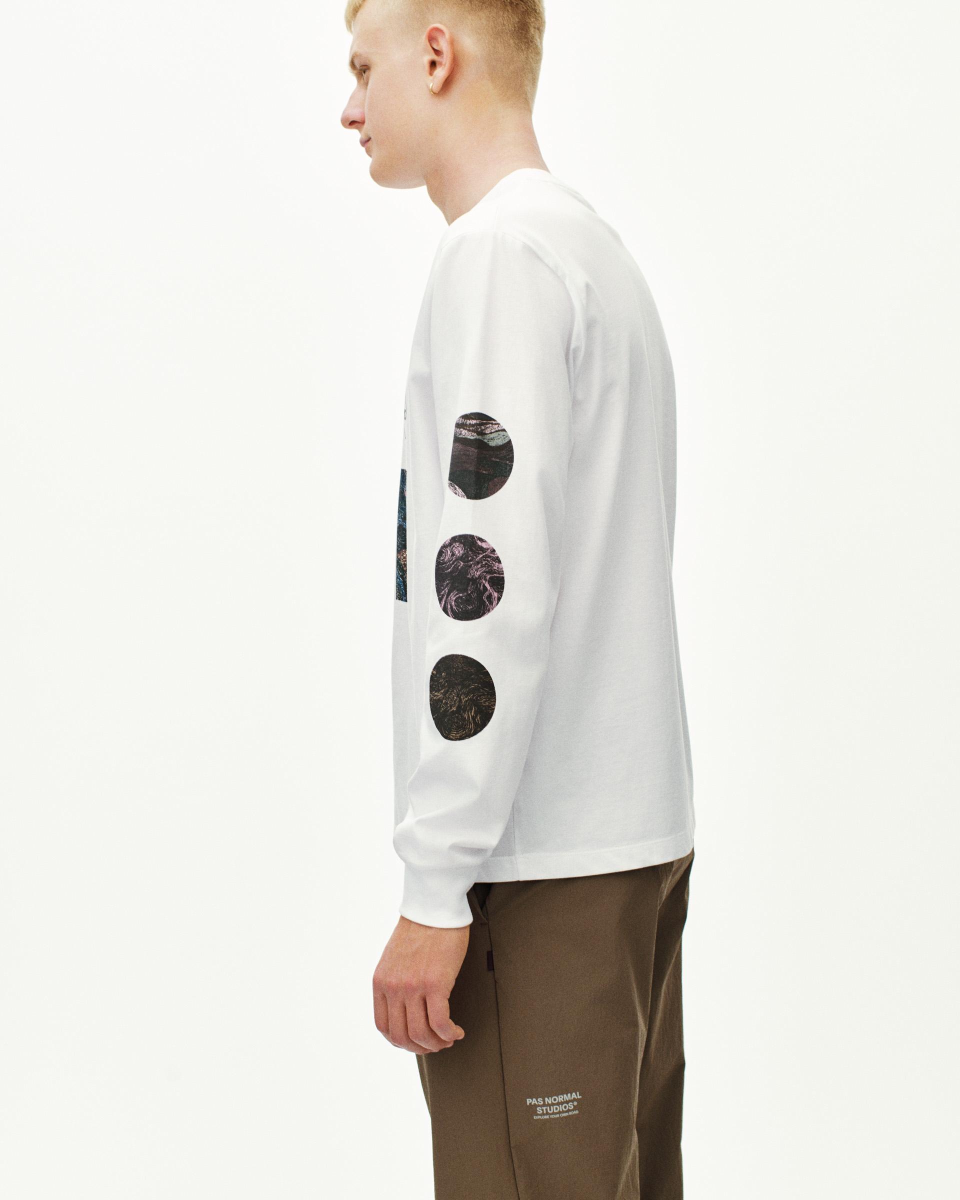 White T.K.O. Off-Race long sleeve T-shirt on model, side view with circular photo prints on sleeve
